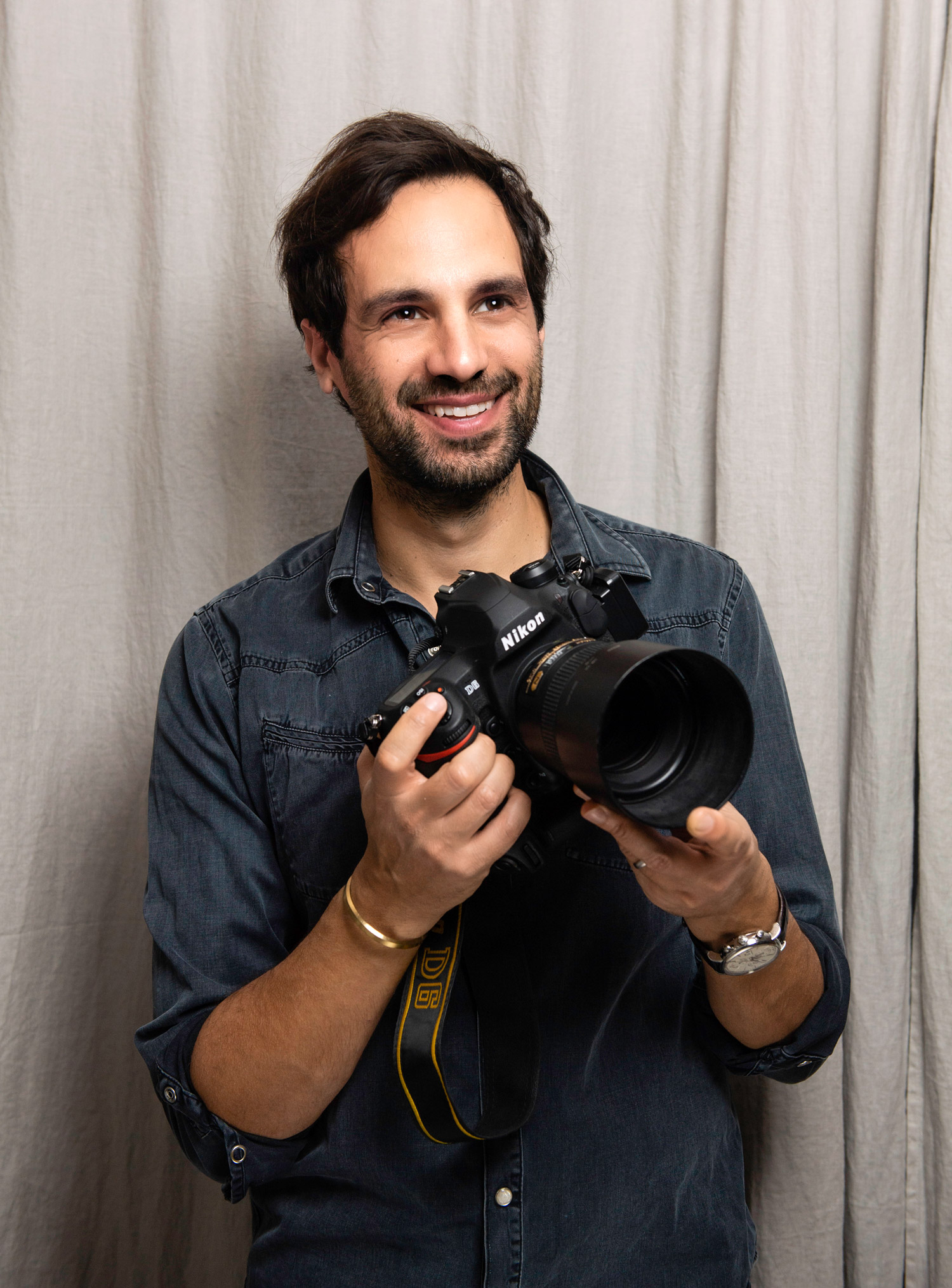 Samir Hussein holding a Nikon D6.