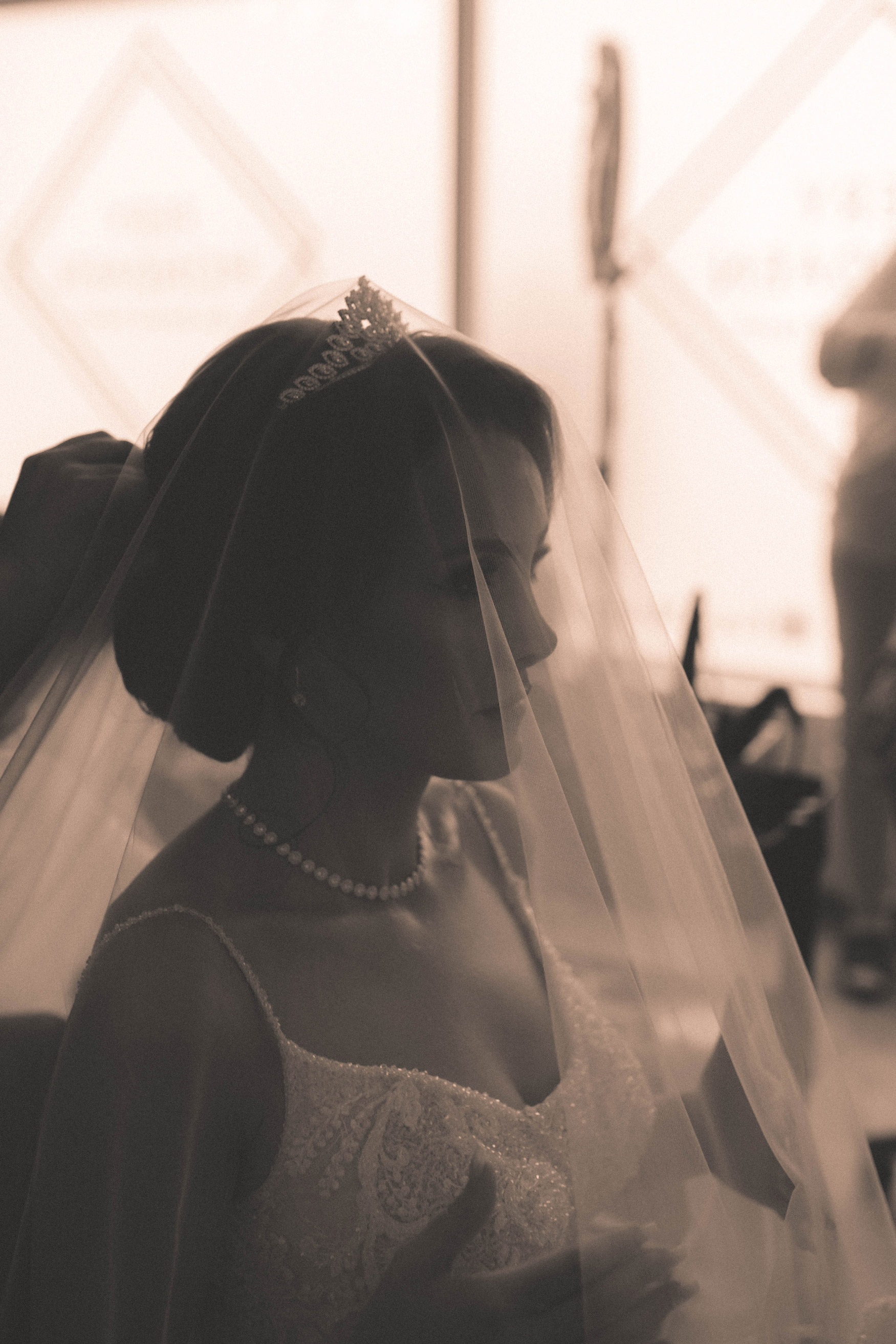 a bride about to lift her veil