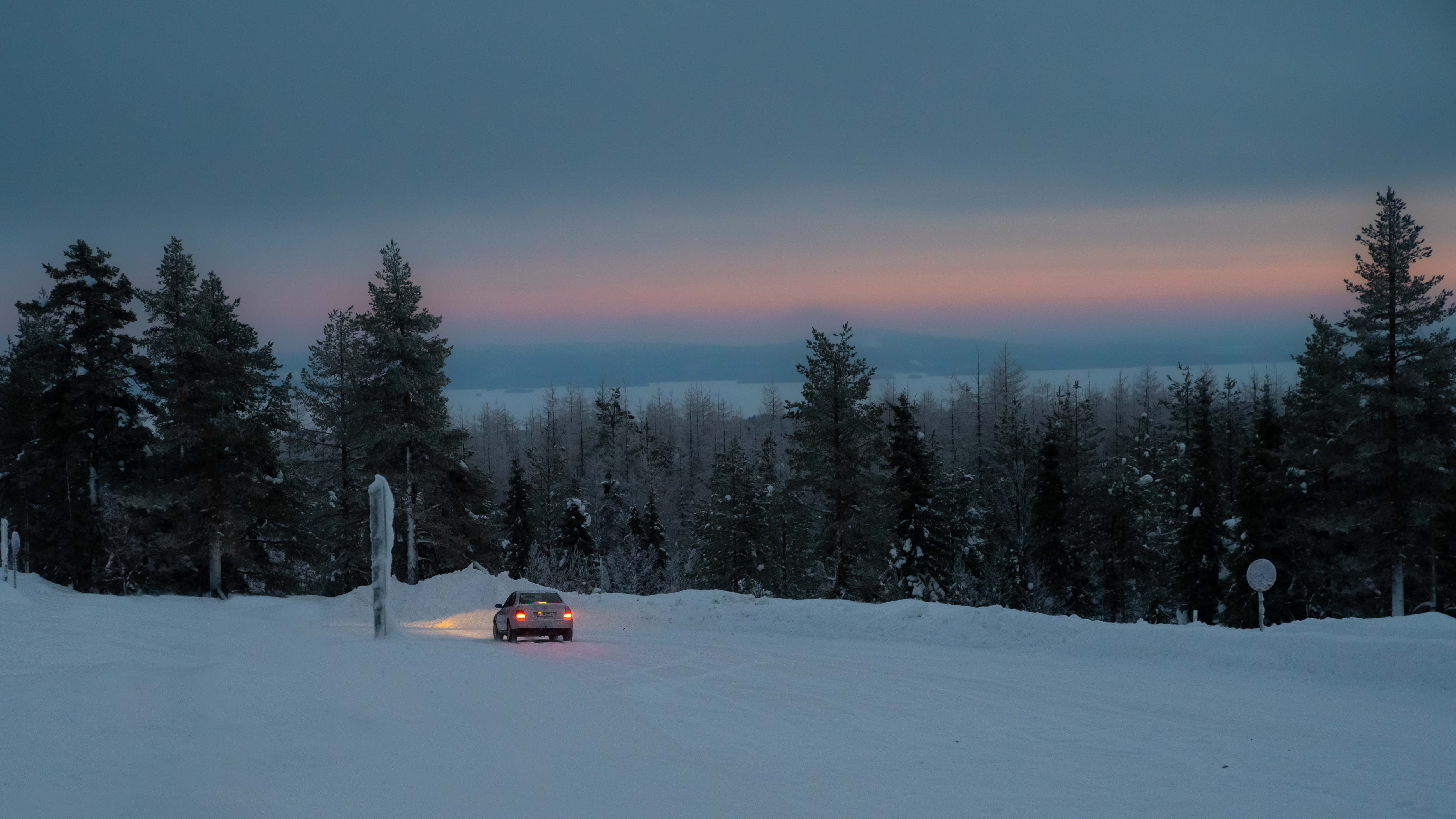 Photograph of two tripods set up side by side with a snowy background. 