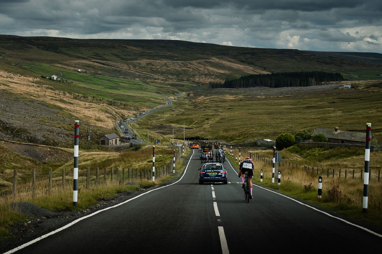 A road in scotland with cyclists and cars