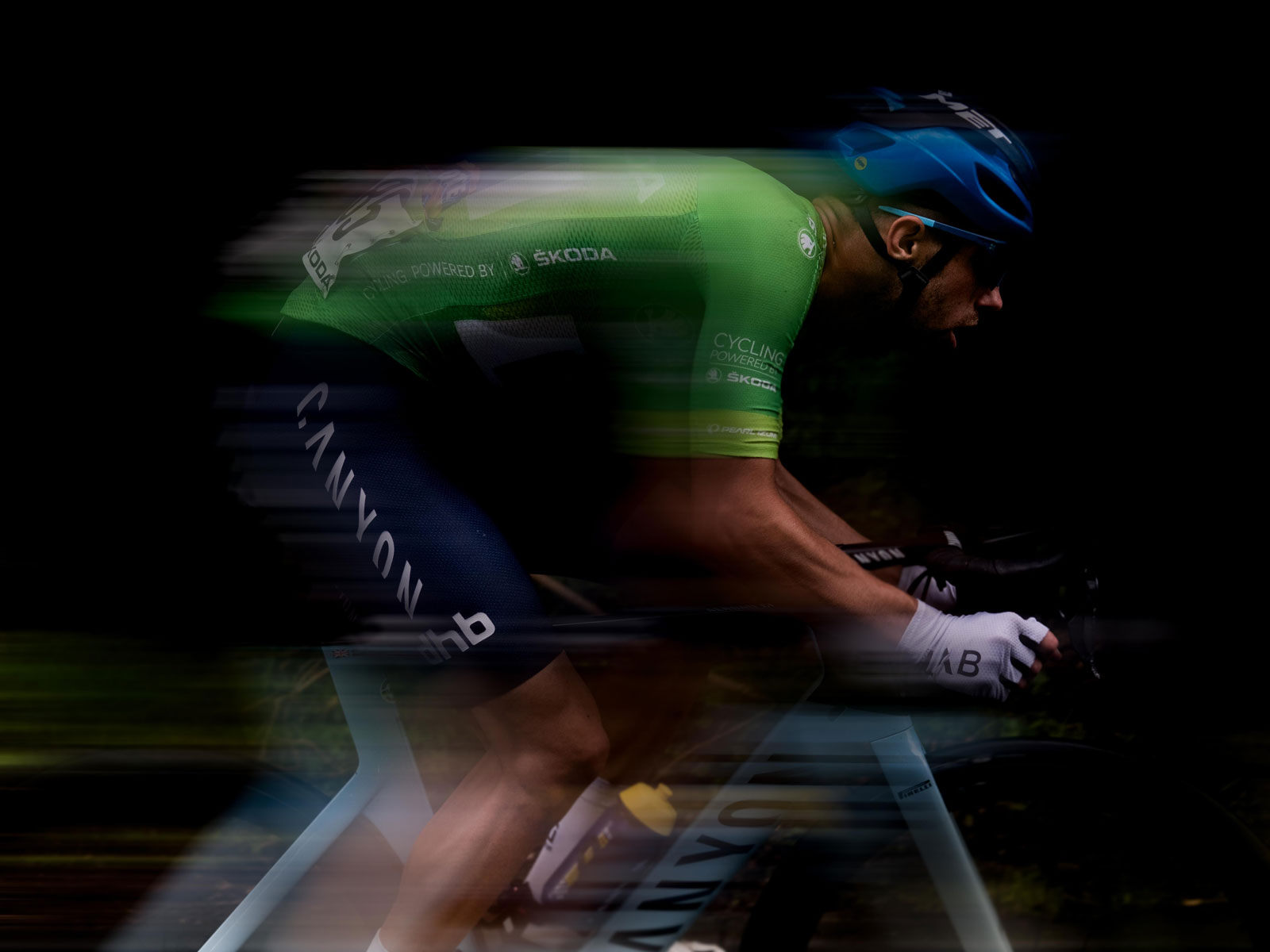 A man in a cycling outfit mid-race. 