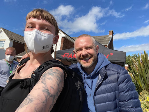 A selfie-style image of Rekha Garton, wearing a black vest and white face mask, and Martin Freeman, wearing a blue hoodie and jacket, on the set of BBC drama The Responder.