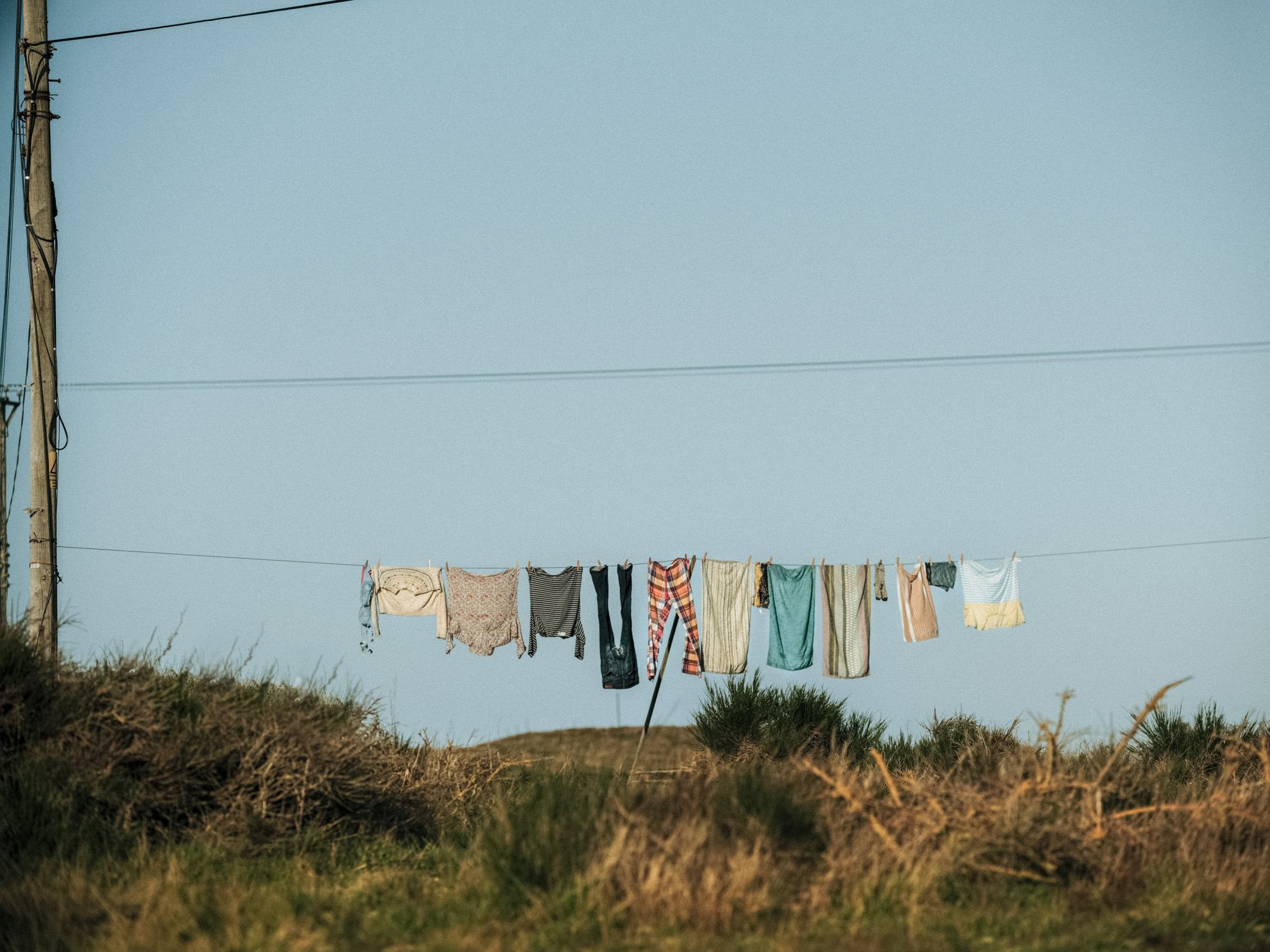 A colour photography of clothes hanging up on a line, shot f/2 @ 100 ISO with ND8 ND filter