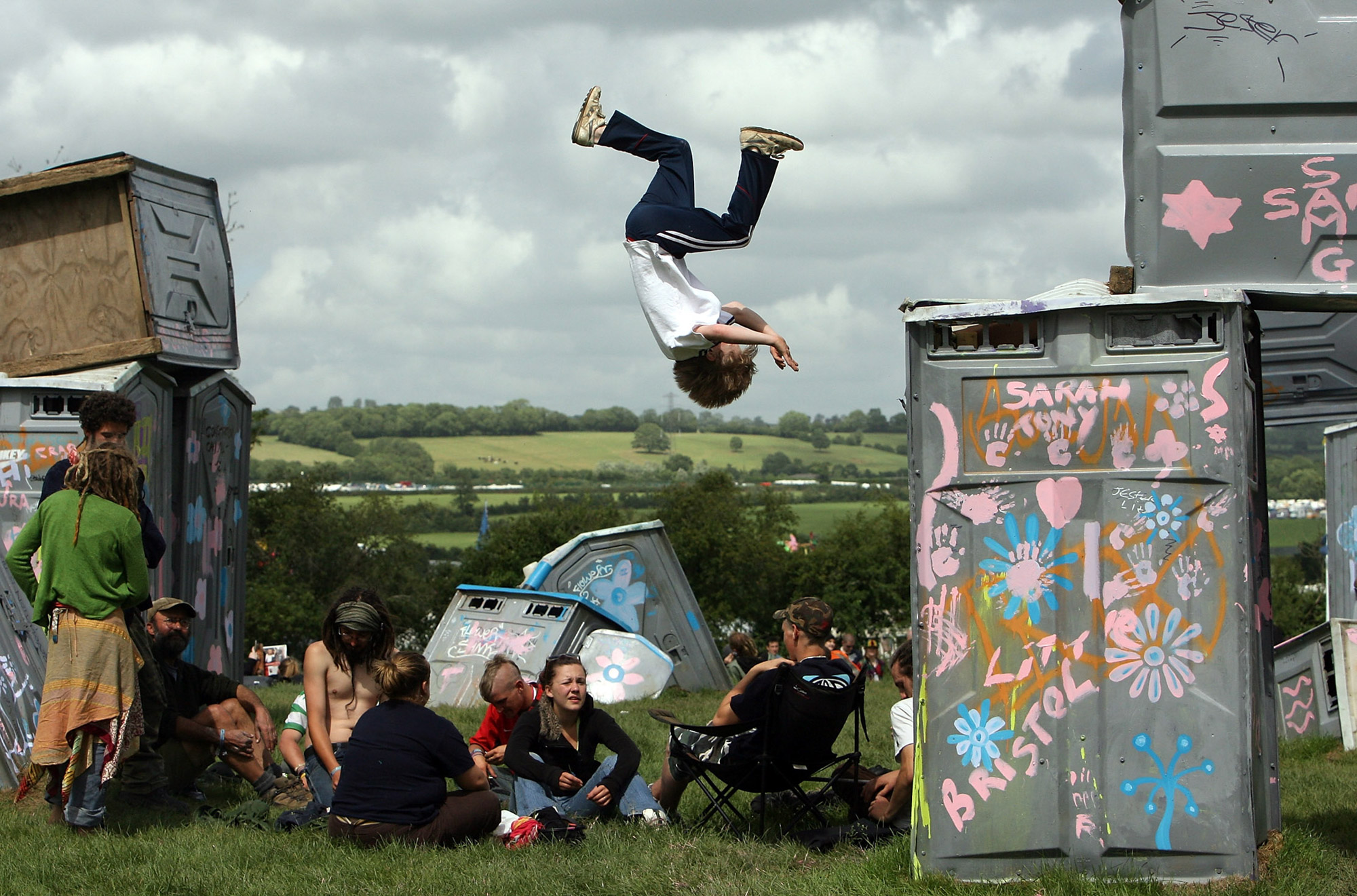 Elliott, 12, jumps of the Banksy 'Stonehenge' installation near to the stone circle at Worthy Farm, Pilton near Glastonbury, on June 20 2007.