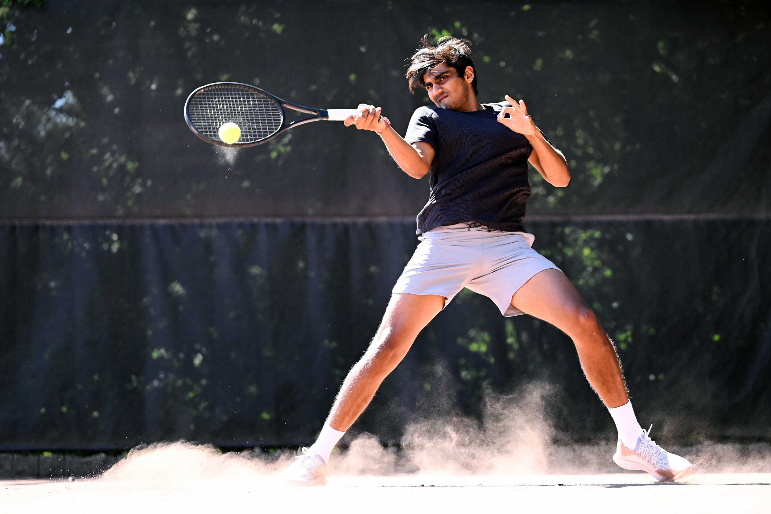 An image of an Asian man playing tennis