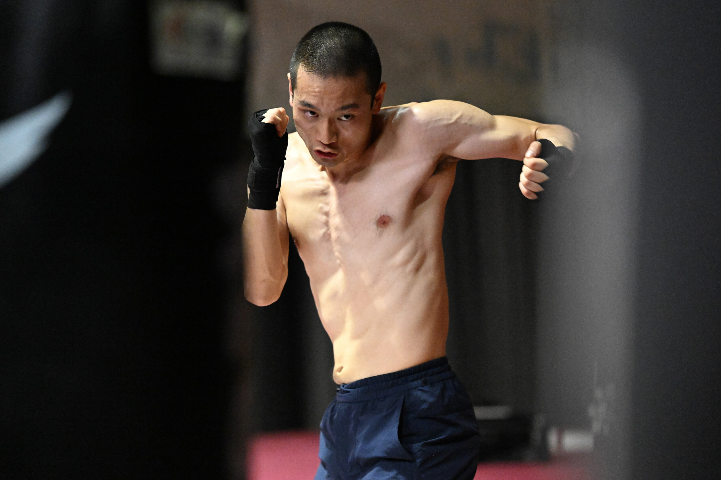 An image of an Asian looking man in a fighting stand