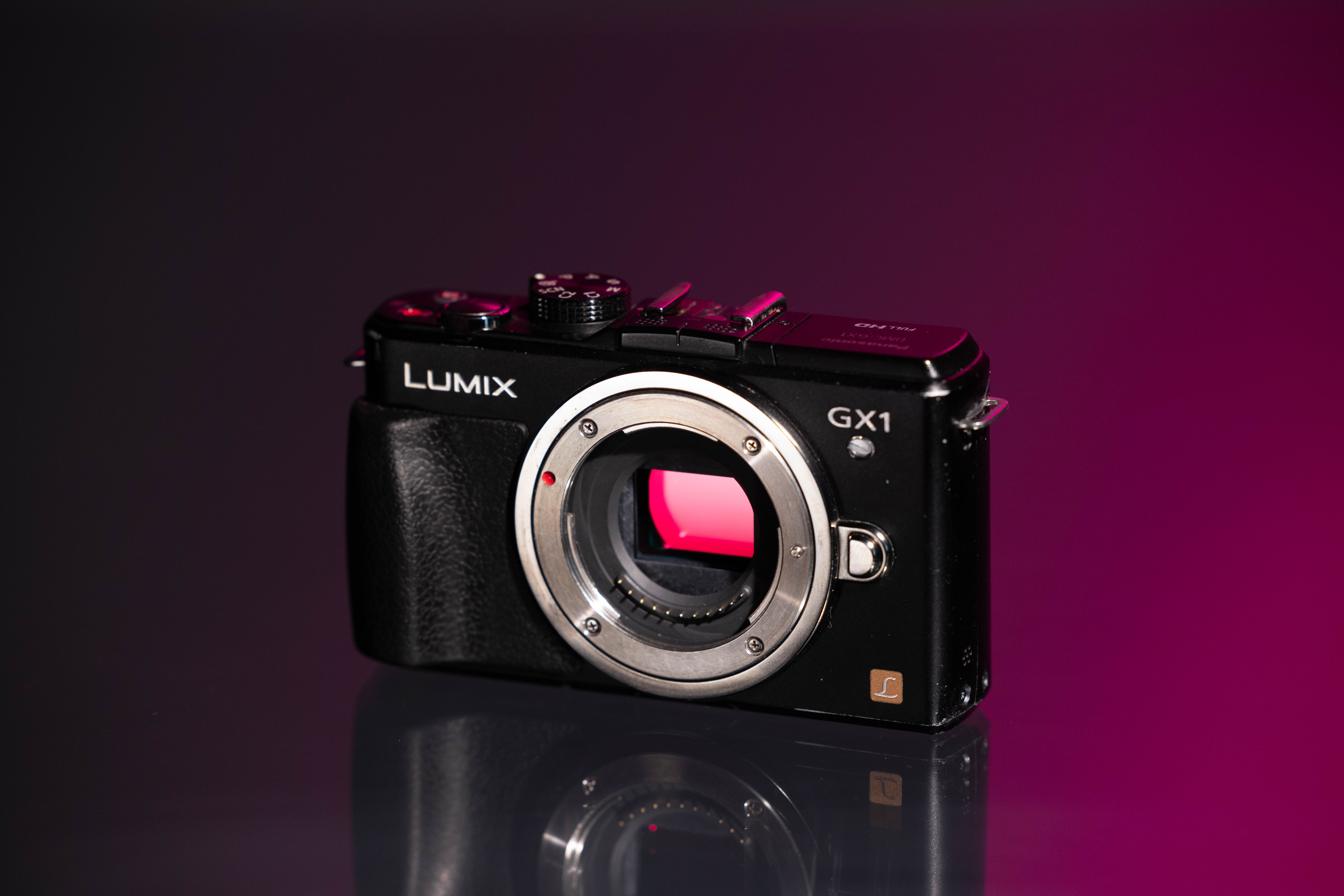 Used Panasonic DMC-GX1 on a pink and black background