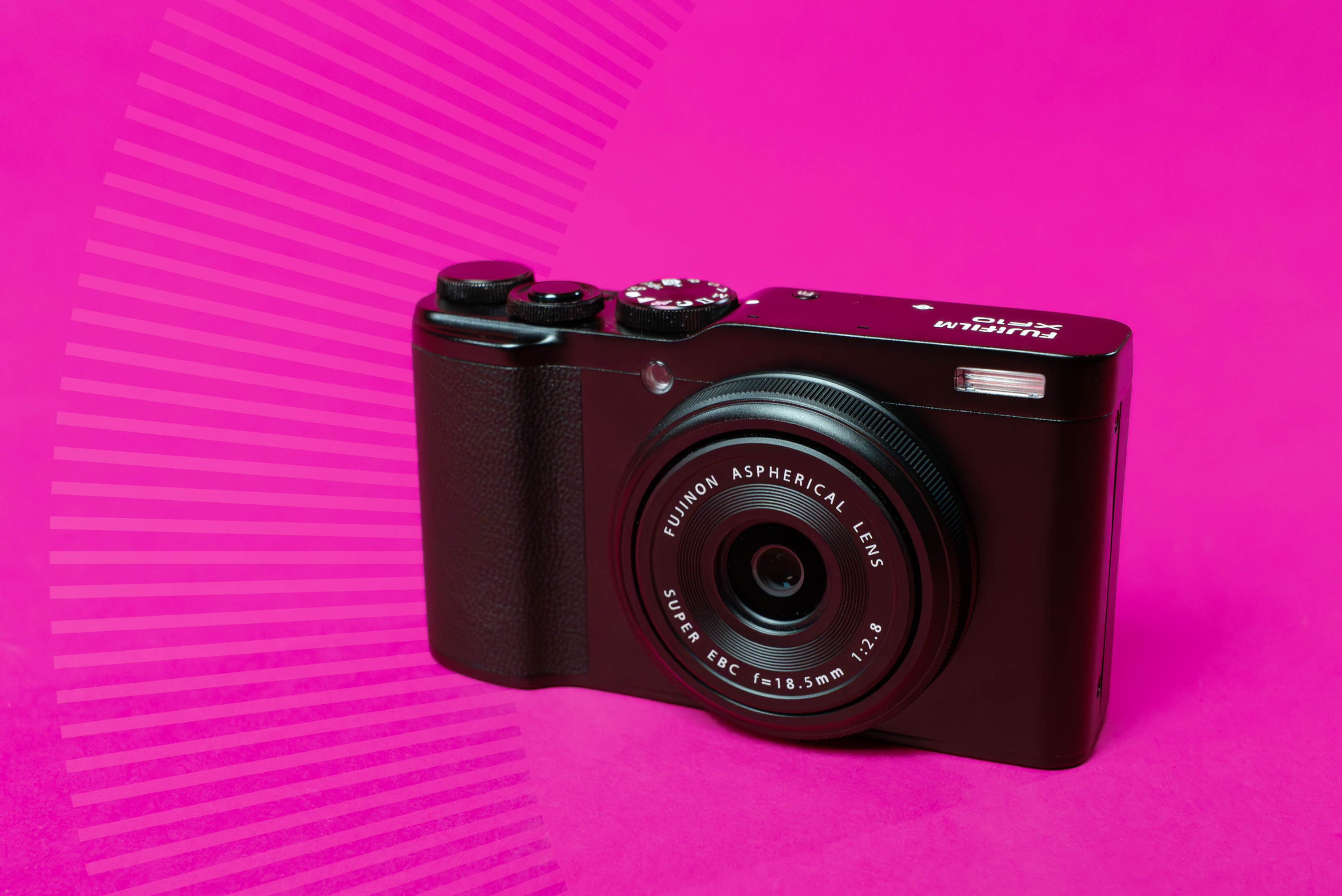 Front of a Fujifilm XF10 on a pink background
