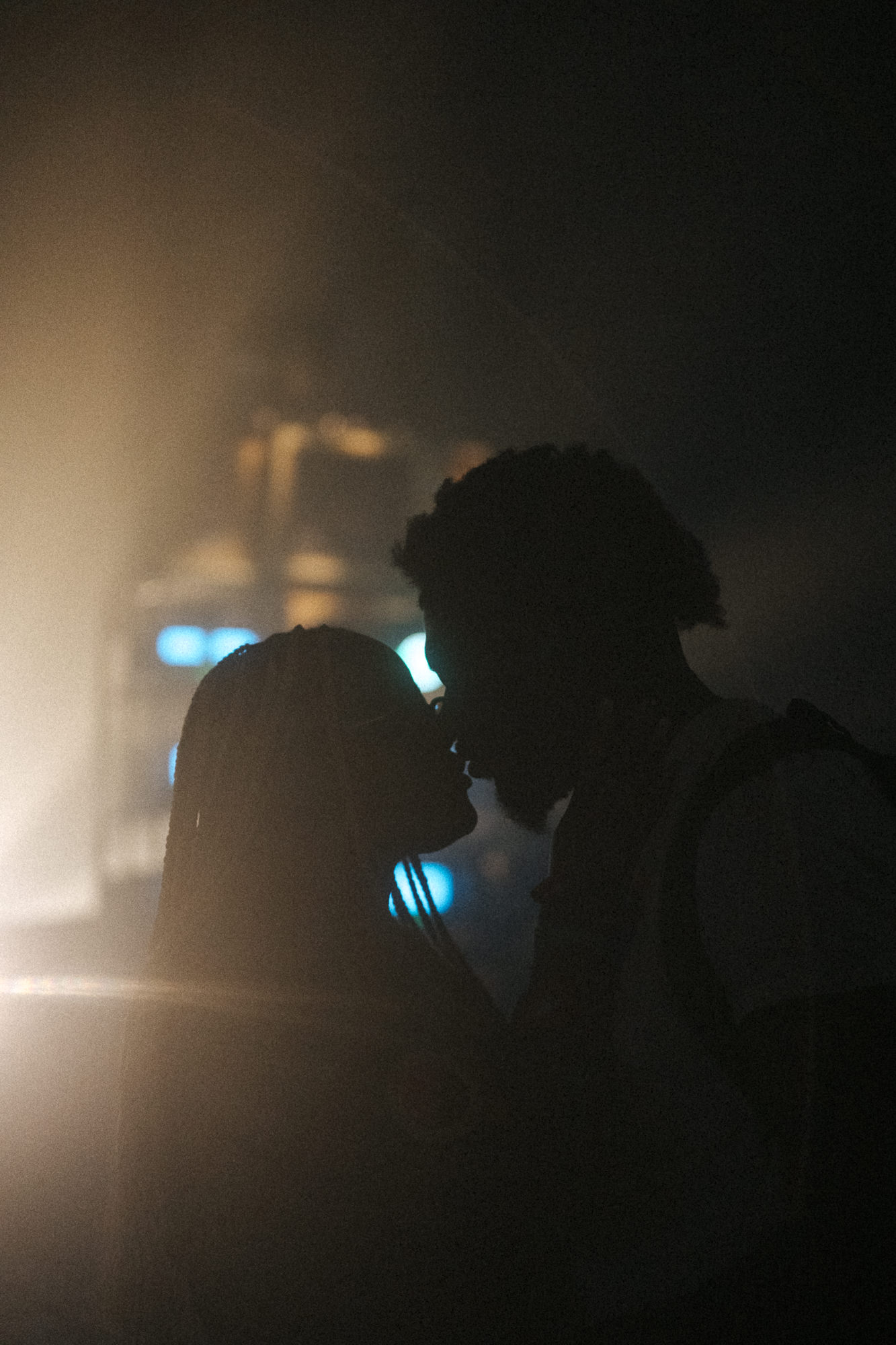 Silhouette of a couple kissing at night during 2023 Coachella Valley Music and Arts Festival.