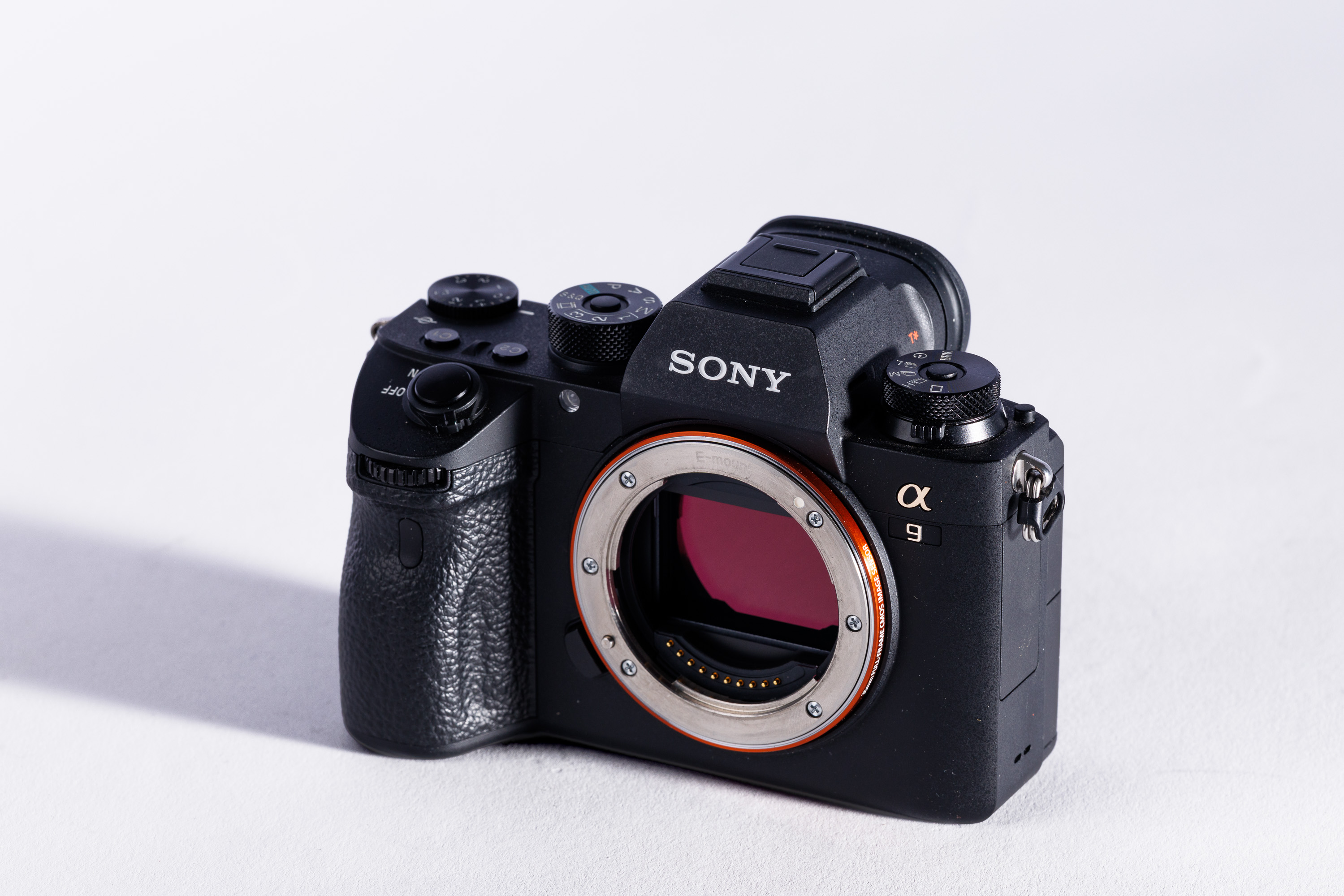 A used Sony A9 on a white background, with a shadow to the left.