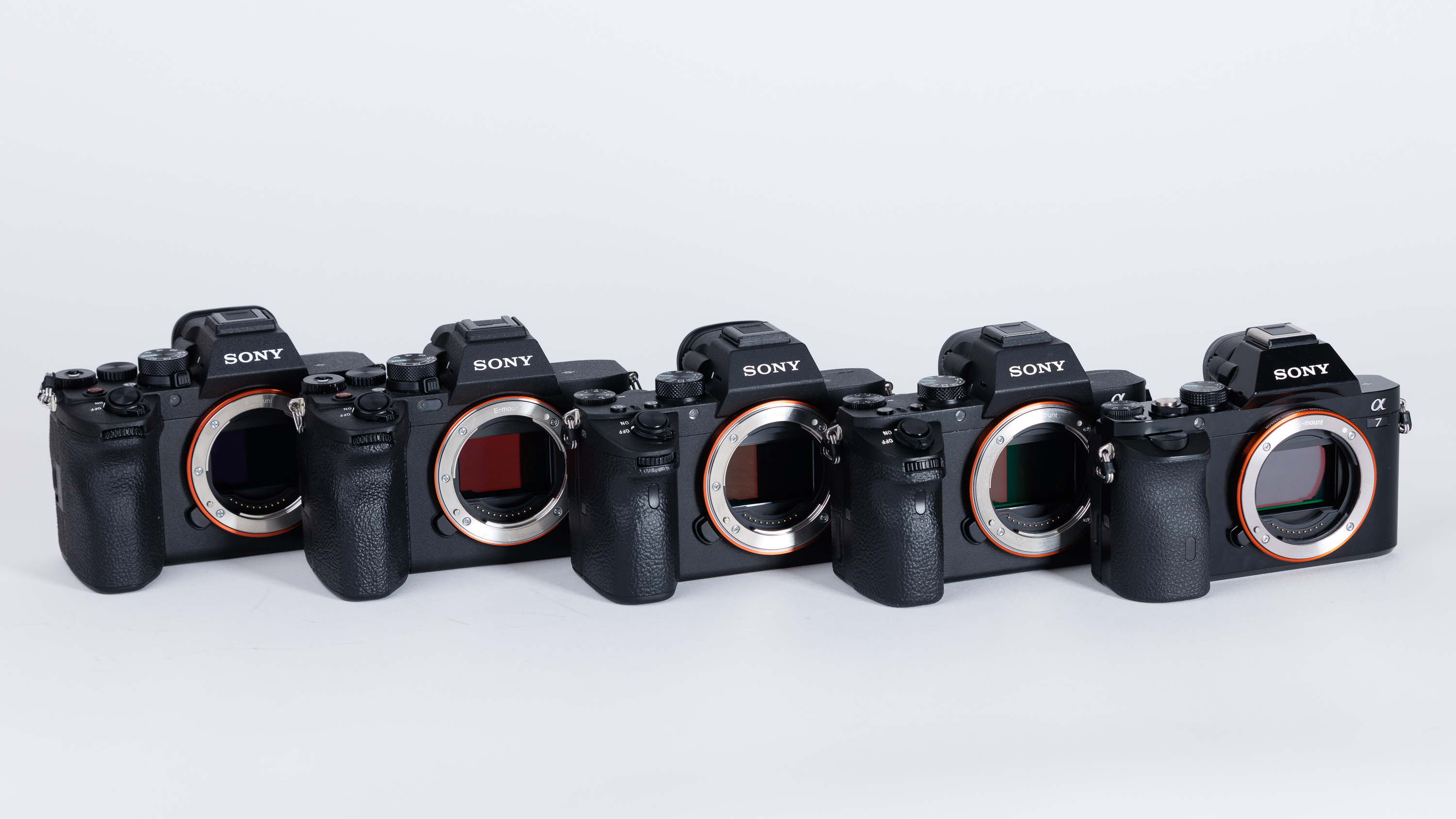 The Sony A7 series on a white background. From L-R: Sony A7 V, Sony A7 IV, Sony A7 III, Sony A7 II, Sony A7