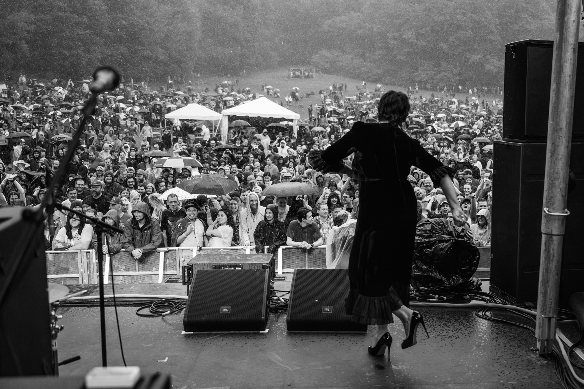 Cat Power on stage during a music festival while raining during a 2023 tour with Modest Mouse and Pixies. Image taken by James Joiner on a Nikon Z9.
