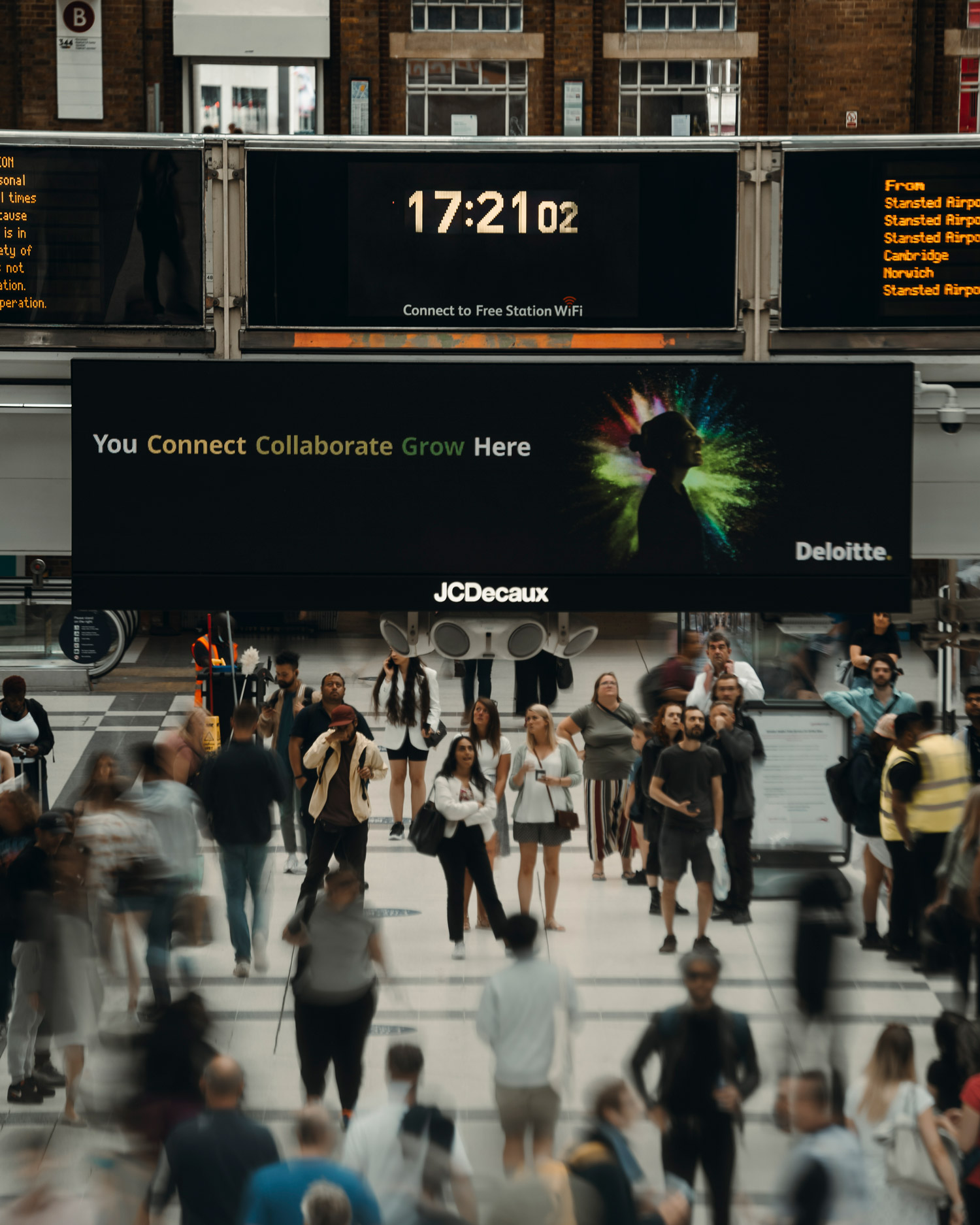 People stand on the concourse at Liverpool Street station in London.