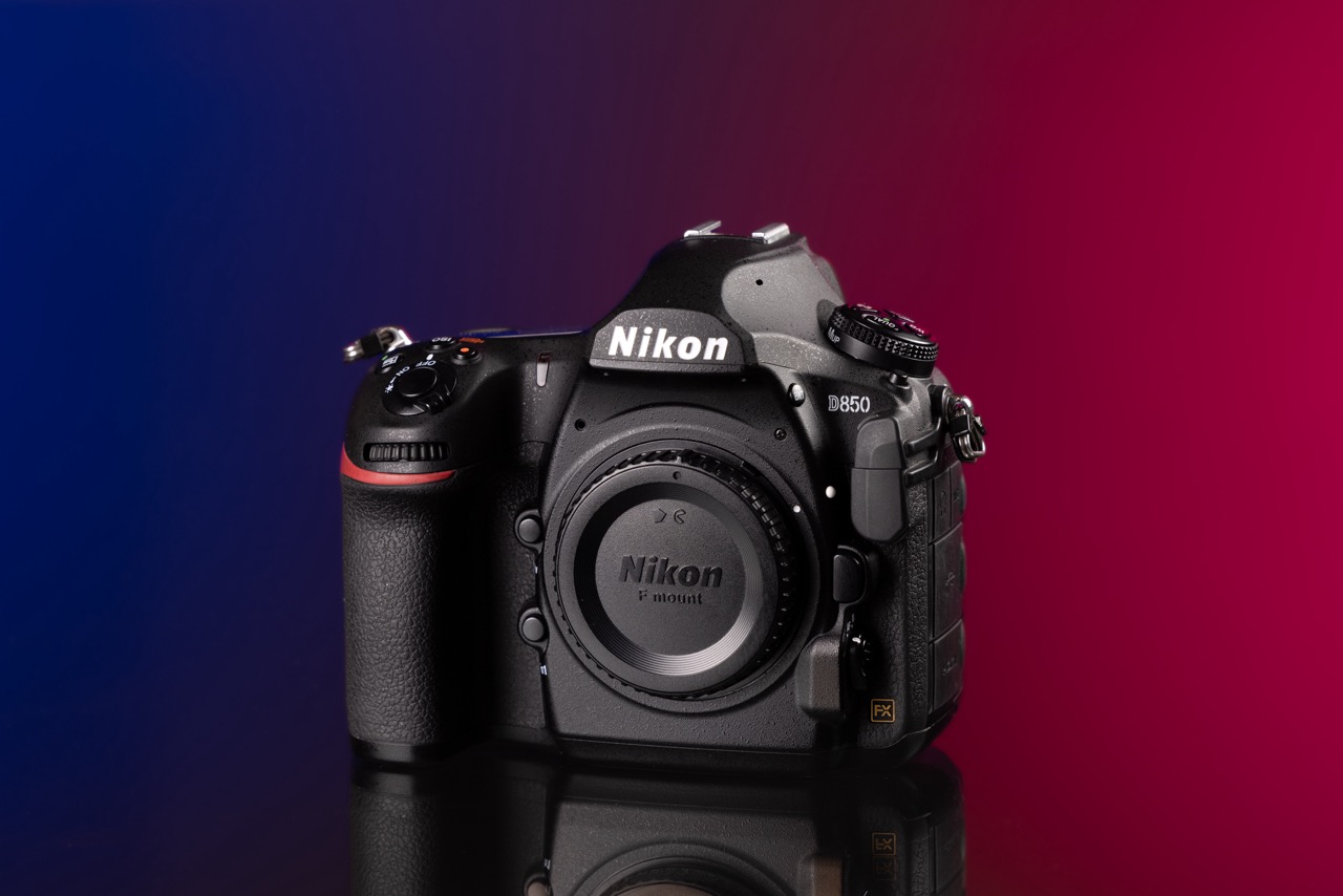 Nikon D850 against a red and blue background