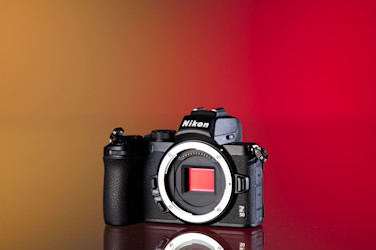 Cámara Nikon Z50 de segunda mano sobre un fondo amarillo y rojo