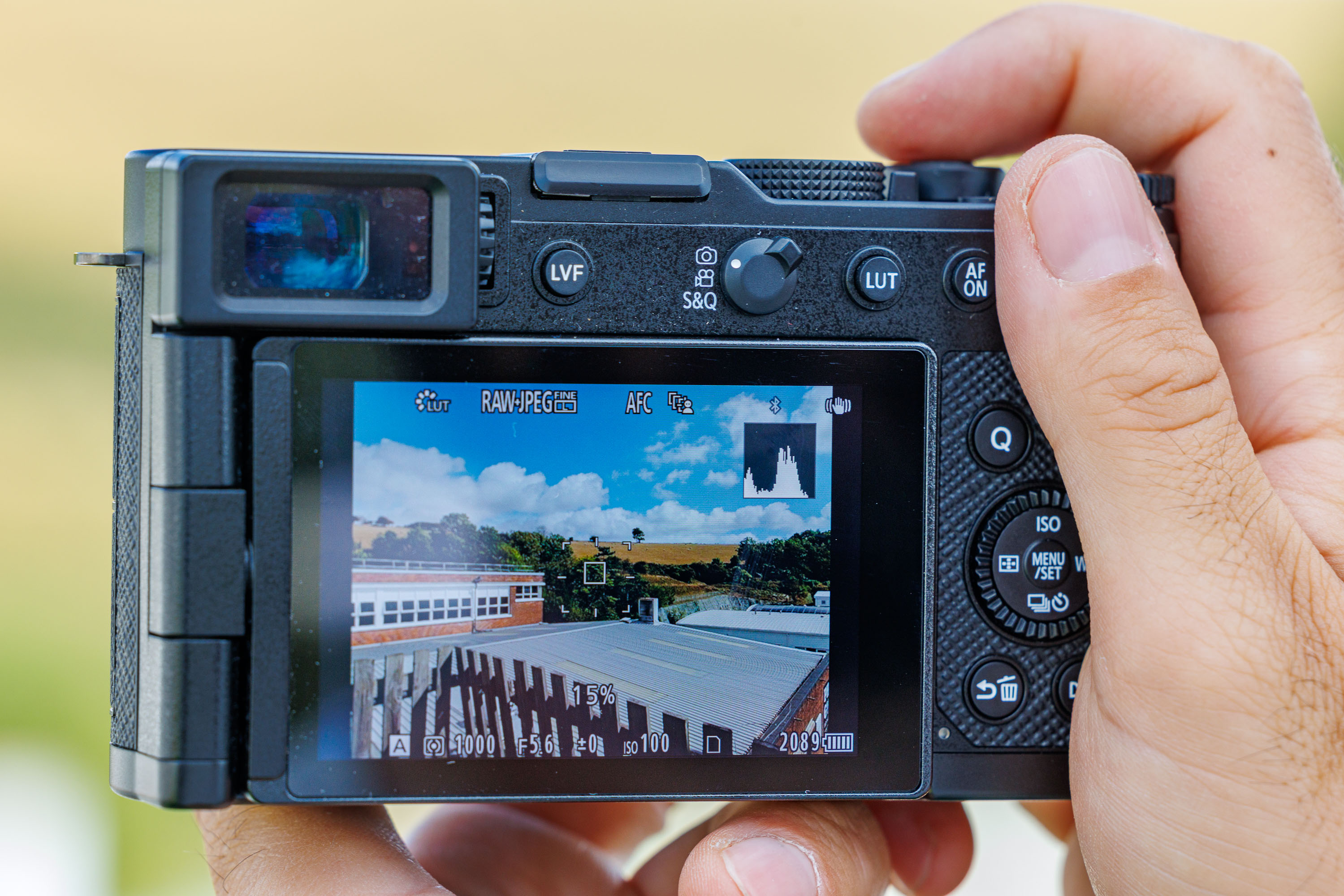Rear screen of the Panasonic L10 in use, showing the live histogram feature in the top right of the screen