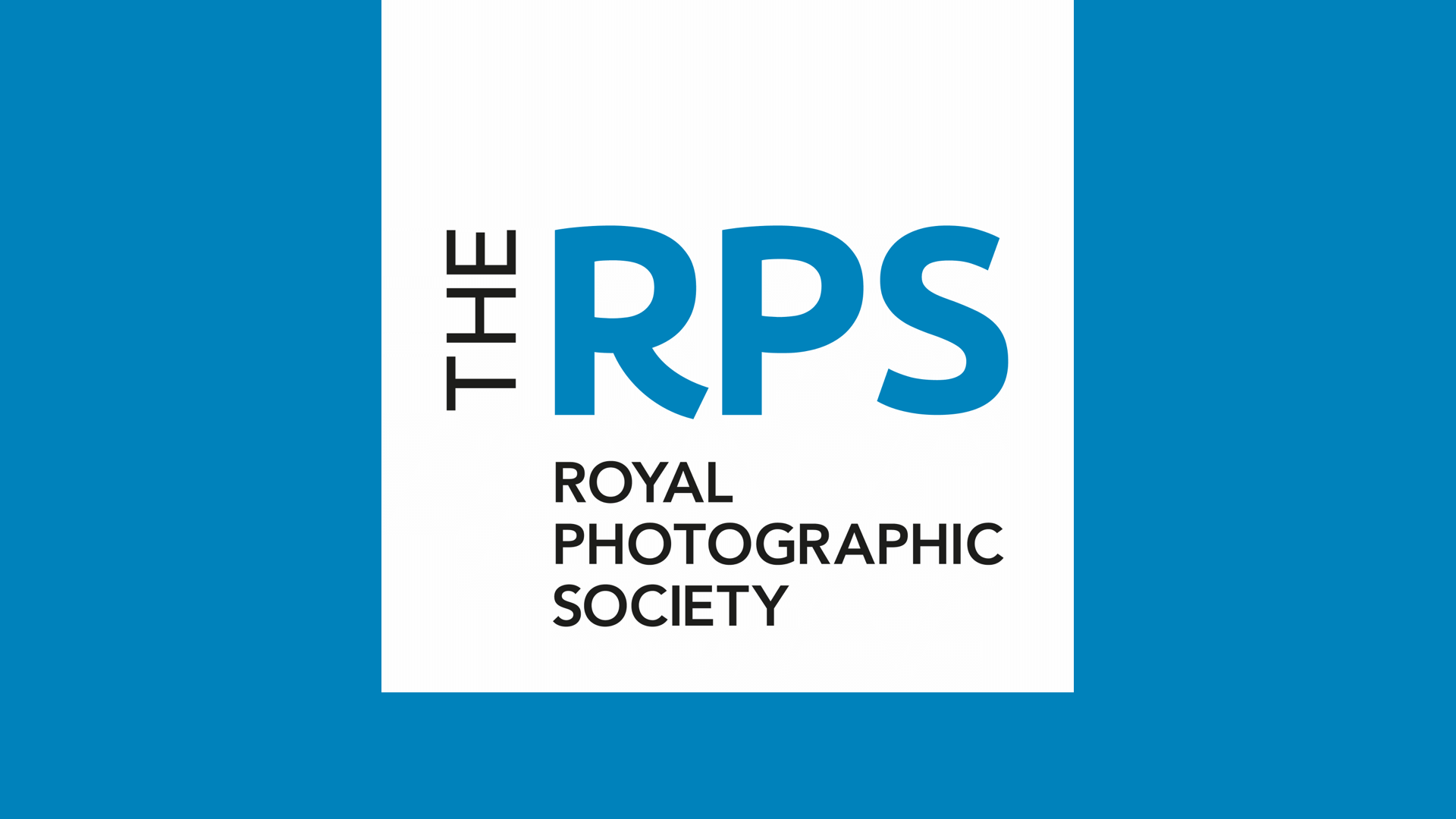 The Royal Photographic Society logo on a light blue background