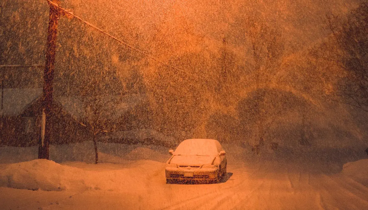car in snow at night