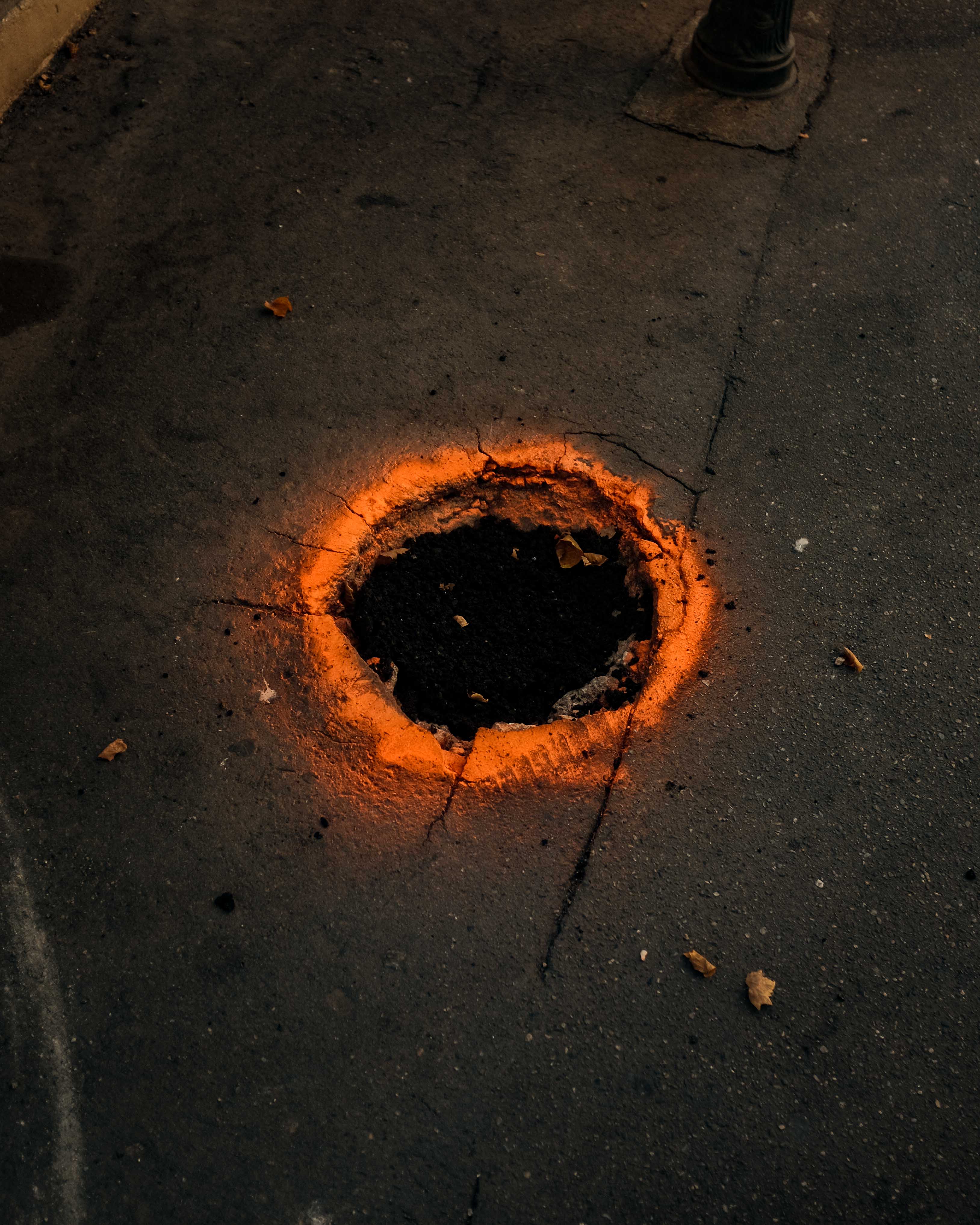 A hole in the street has been highlighted by orange paint. Taken on the Fujifilm X100T by Connor Redmond.