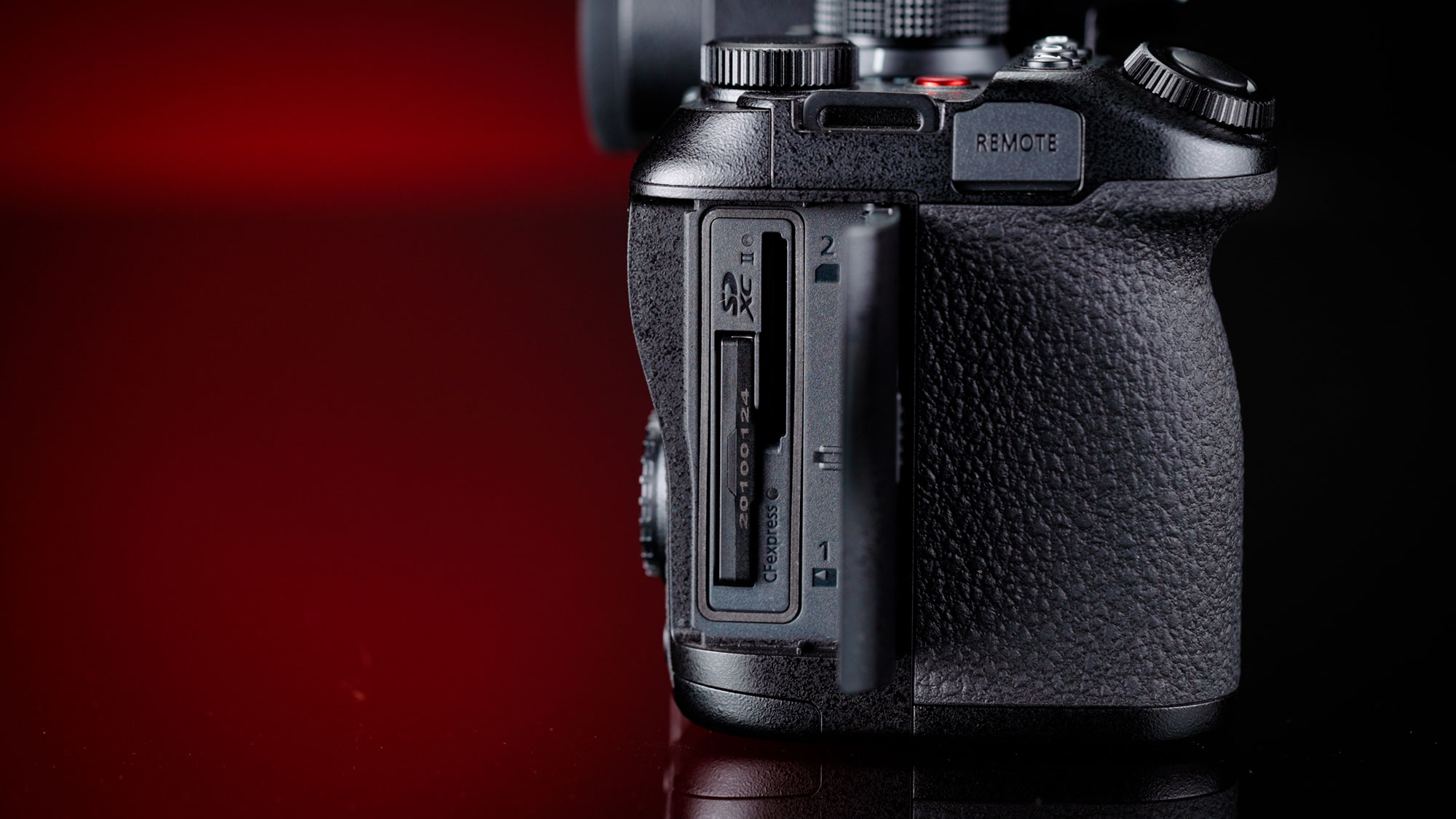 The Panasonic S1R II with its media port door open, showing its dual storage, one CFExpress Type B and one UHS-II SD