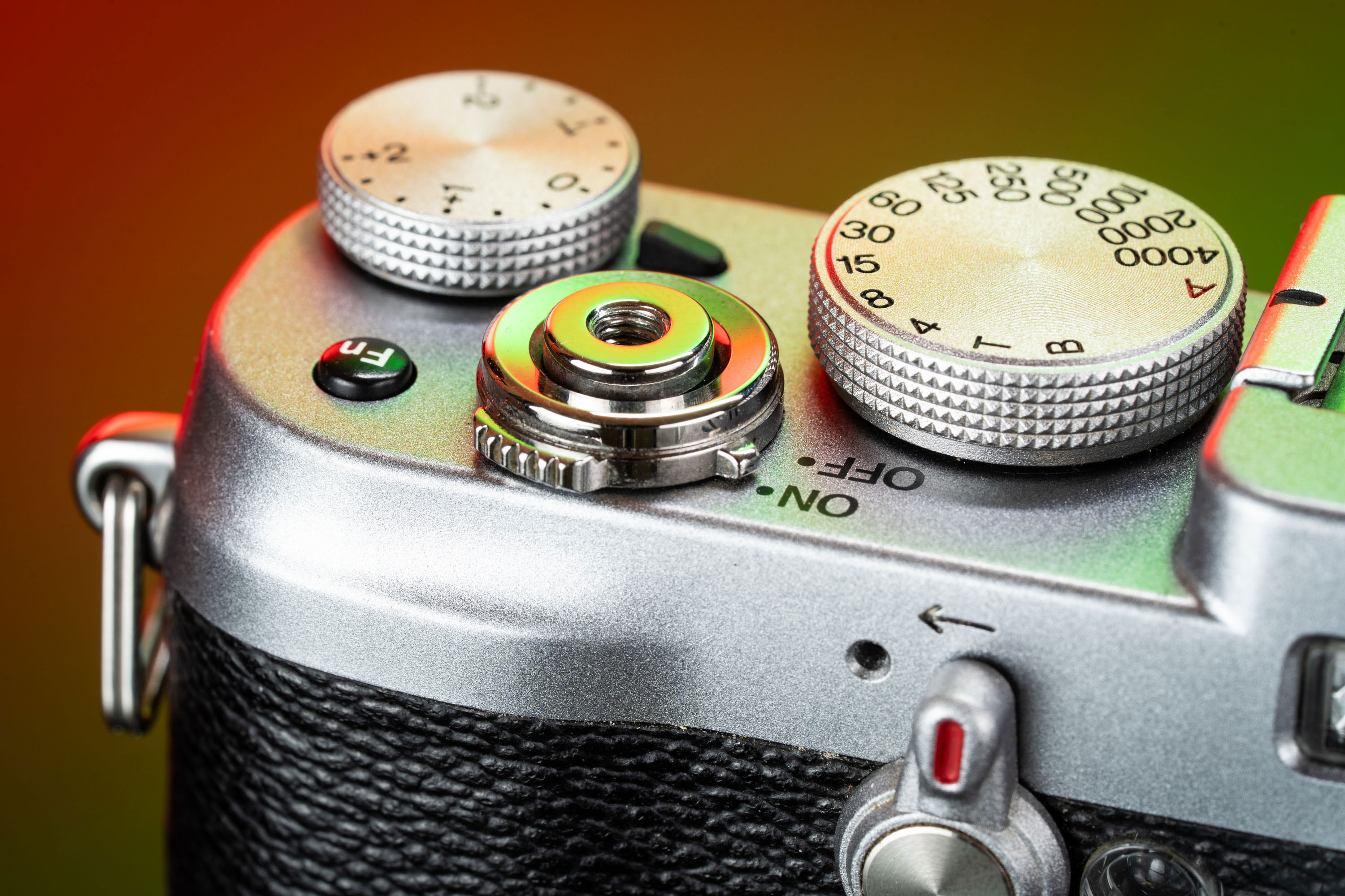 A close-up of the top dials of the Fujifilm X100