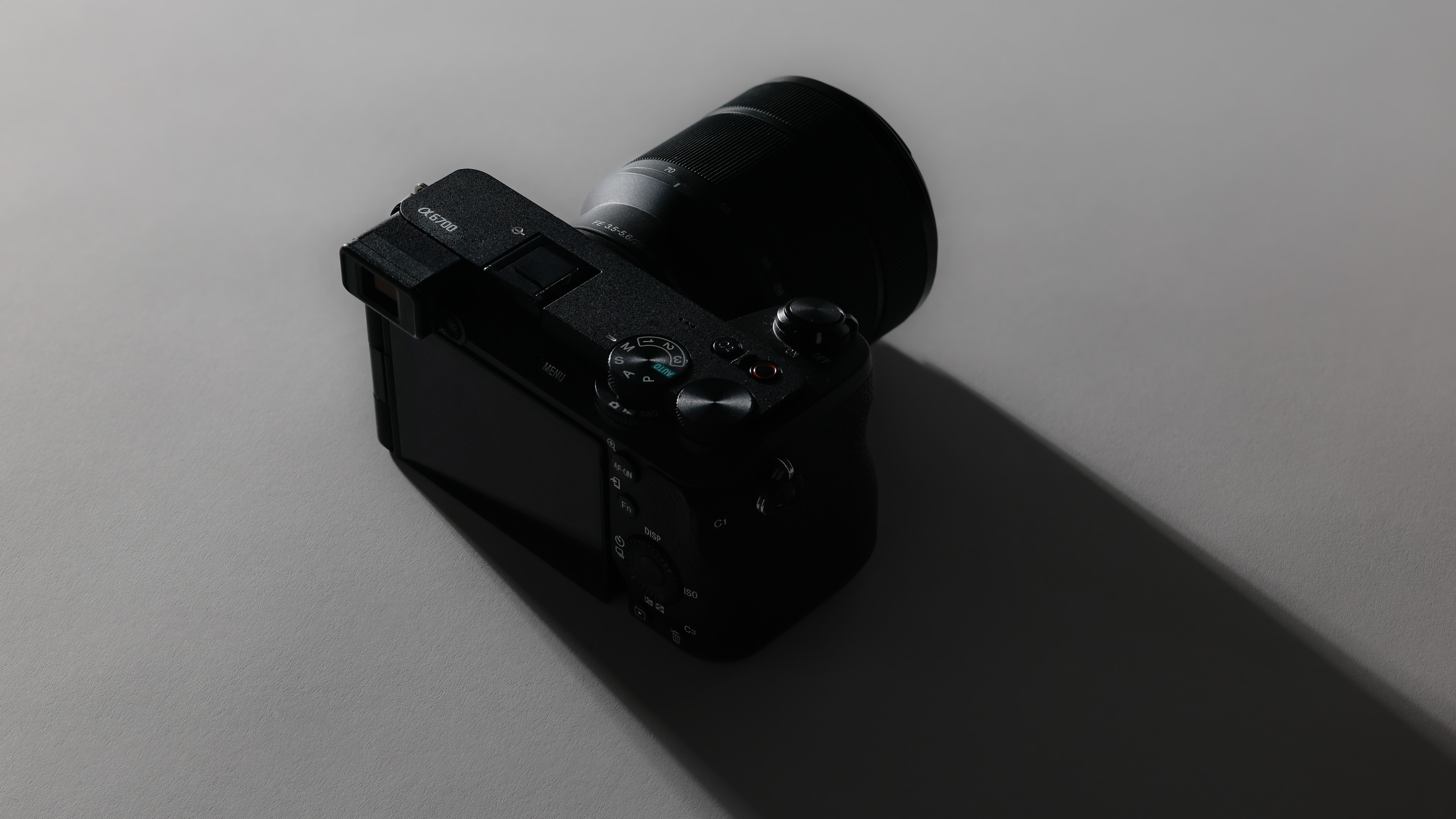 A secondhand Sony A6700 and Sony FE 28-70mm f/3.5-5.6 OSS with a strong dark shadow being cast 

