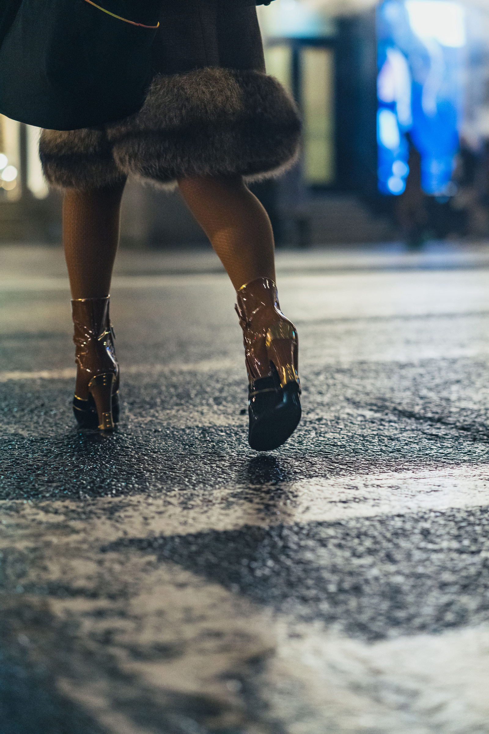 Person with high heel shoes walking through crosswalk, photo by Manuel Pena on a Sony A7 III.