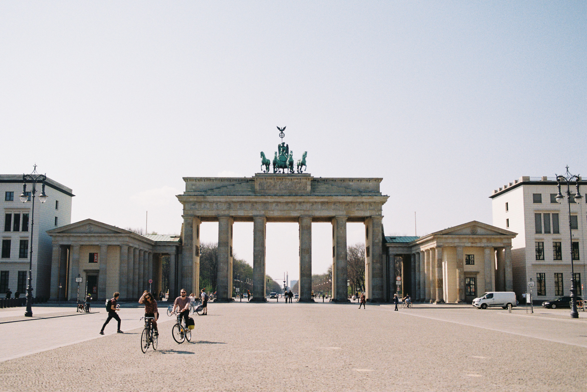 Heads-on view of Brandenburg Gate from Pariser Platz on a sunny morning. Shot by Austin Fassino on 35mm film.