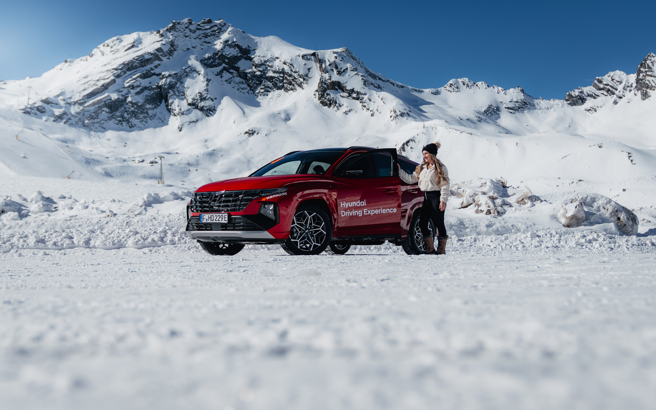 Woman stands next to a red Hyundai SUV on a glacier surrounded by snow in Austria.

Max Loewenstein | Sony A1 | 29mm | f/2.8 | 1/2500 | ISO 100