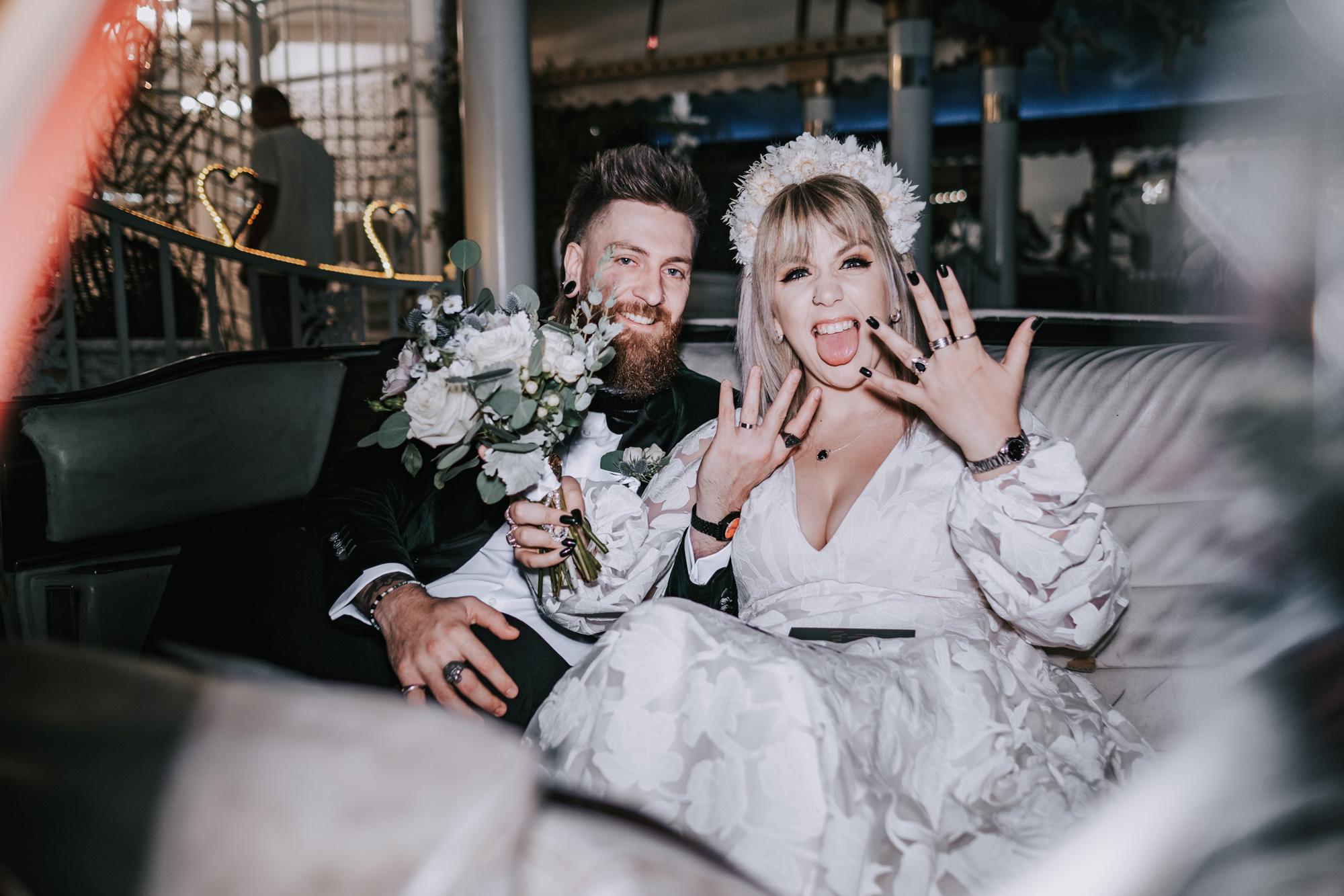 A bride and groom at a wedding, the bride is holding out her hand showing her new bridal ring and a bouquet of flowers. Shot by Matthew Palmer with a Fujifilm X-T4.