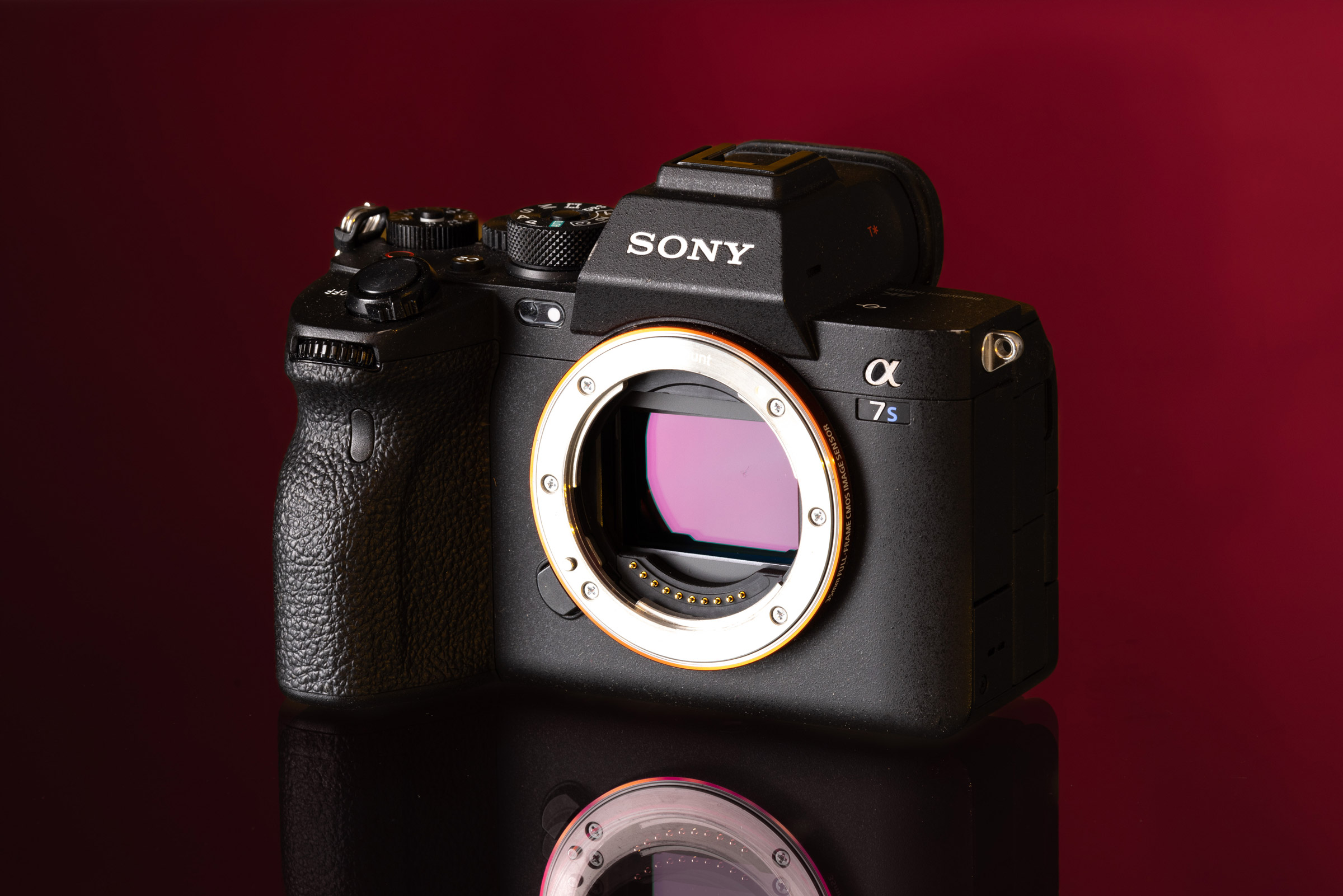 Sony A7S III on a cherry red background.