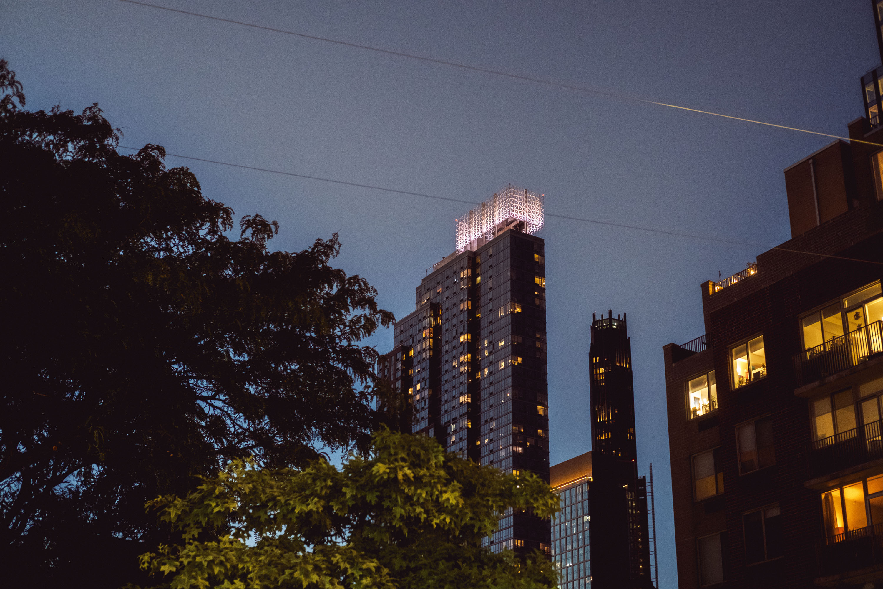 A skyscraper at night with glowing orange lights emanating from within. Shot on the X-Pro 3 by Ian Howorth.