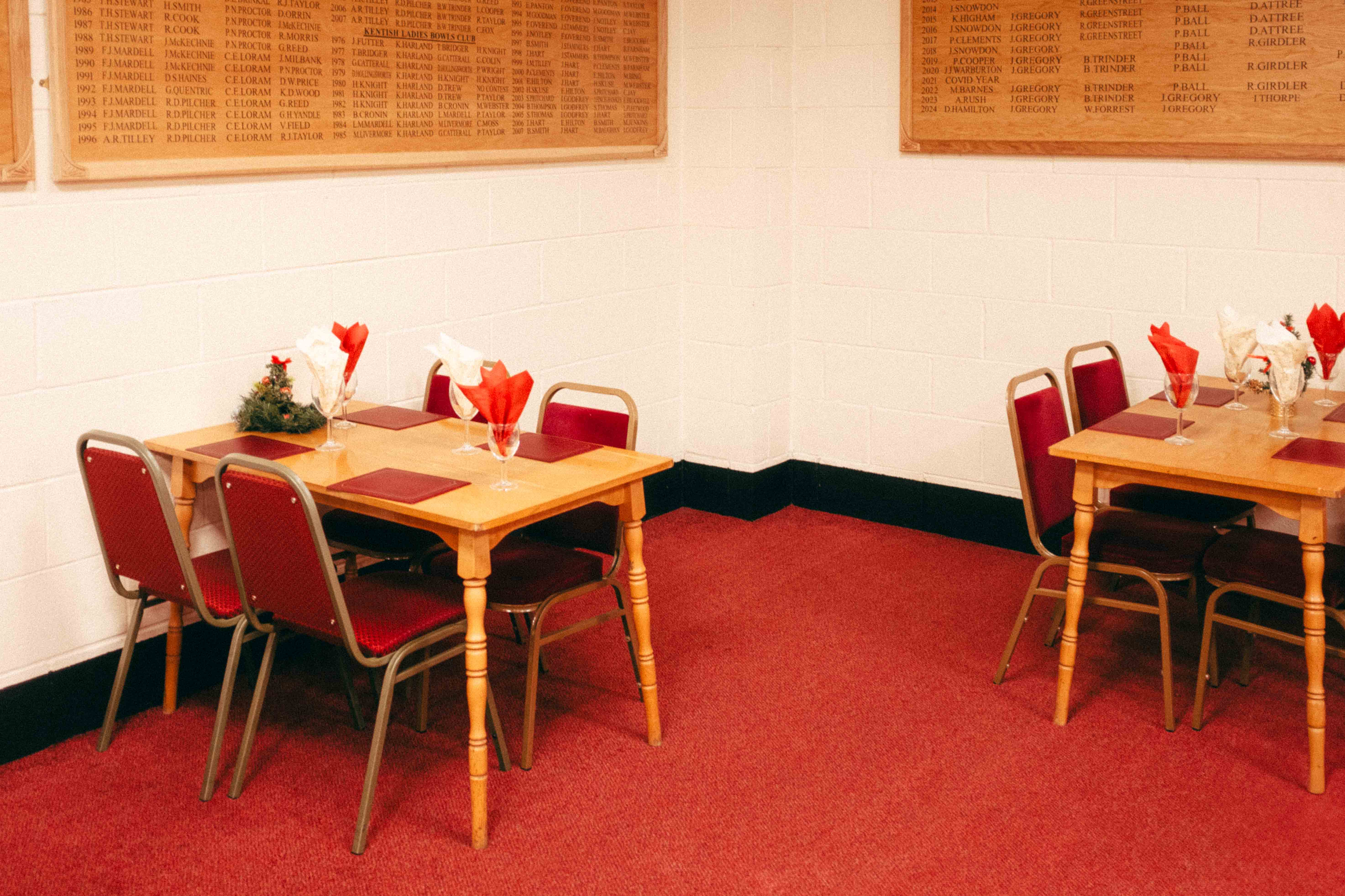 A ‘Lynchian’ looking image of two tables made up with red carpet and red chairs. Taken by Connor Redmond on the Fujifilm X100F.
