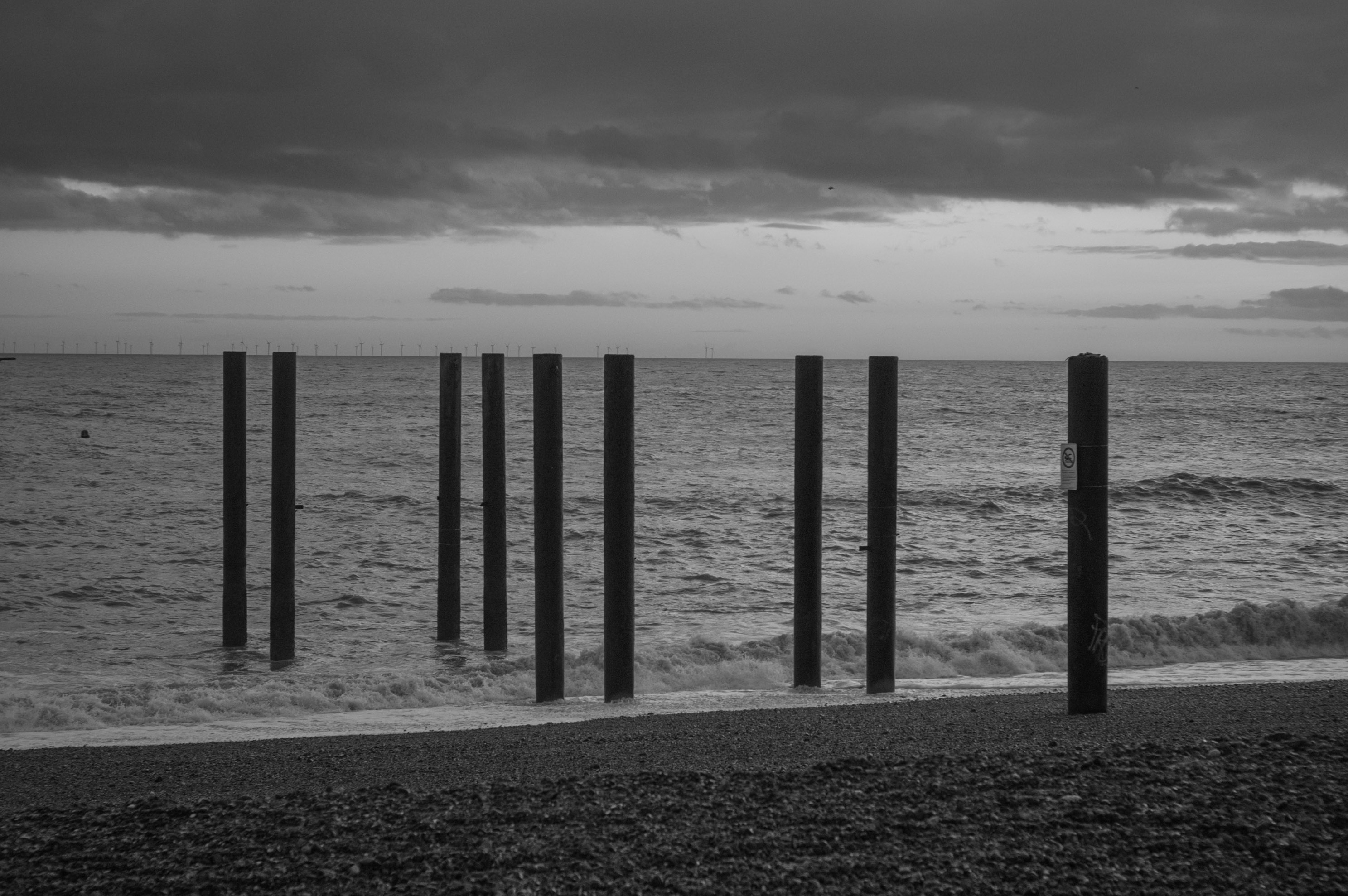 The old stilts of the old Brighton Pier stick out the beach, which perfectly lines up with the horizon. By Ian Howorth.