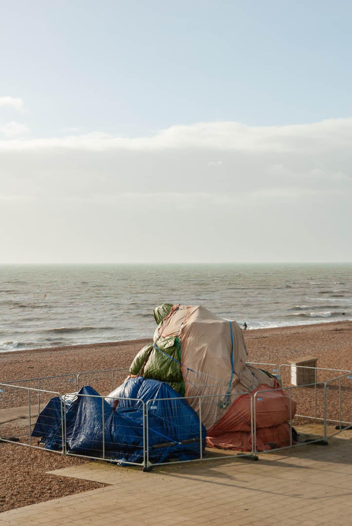 Covered up fair ground rides on Brighton Beach, England by Jakub Golis


