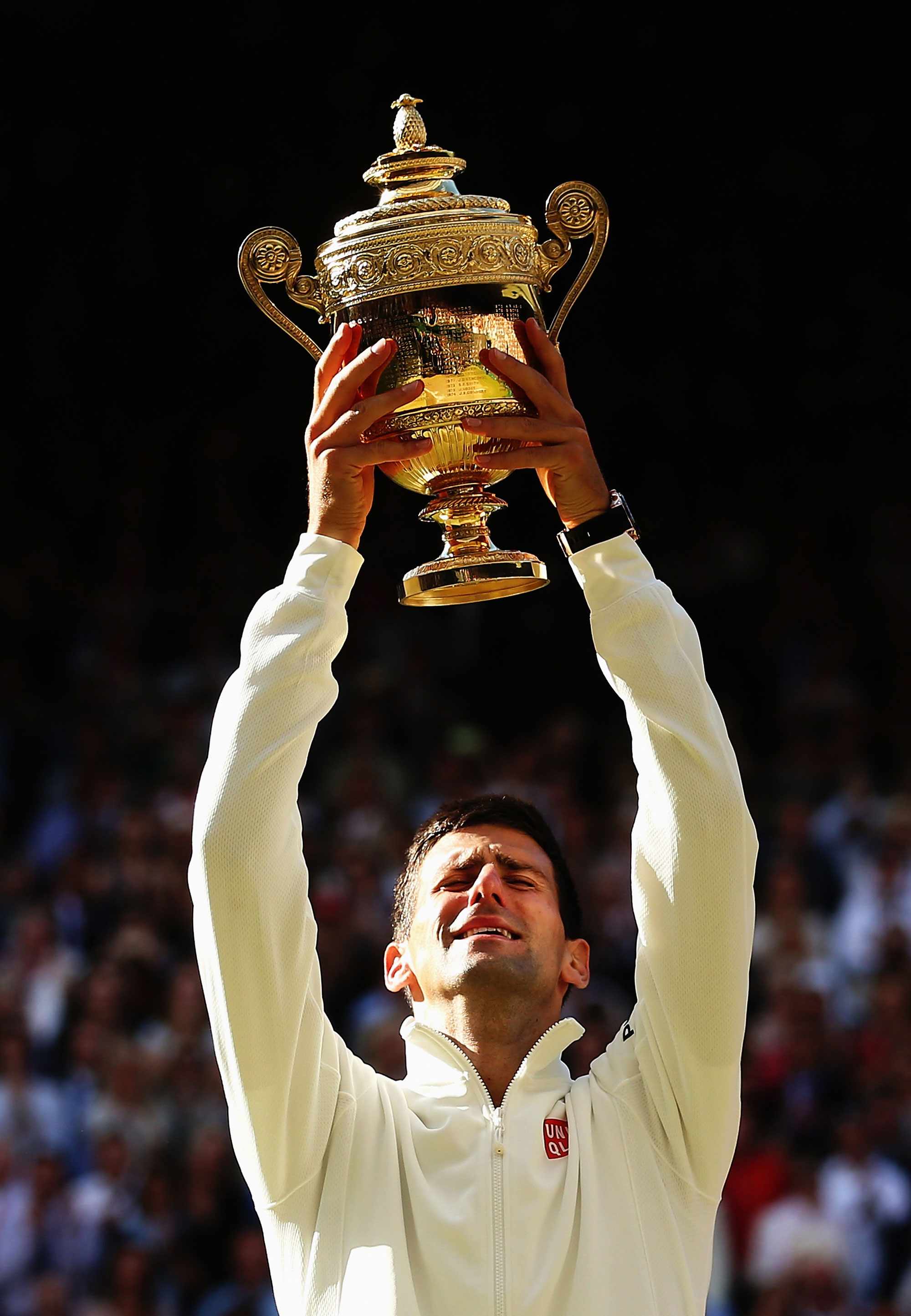 Novak Djokovic of Serbia poses with the Gentlemen's Singles Trophy following his victory in the Gentlemen's Singles Final match against Roger Federer of Switzerland.