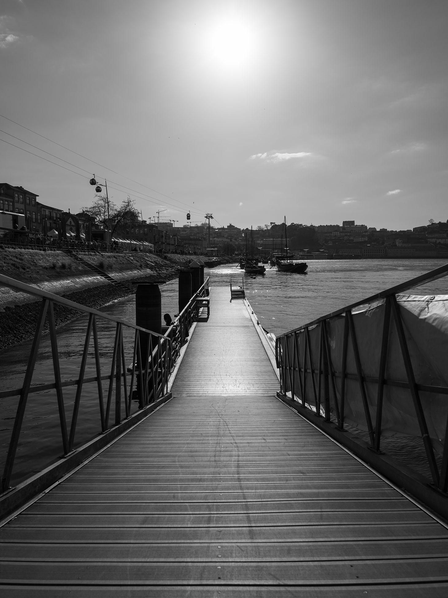 Black and white shot of steps leading down to a dock. Shot on the Fujifilm GFX100RF by Amy Moore.