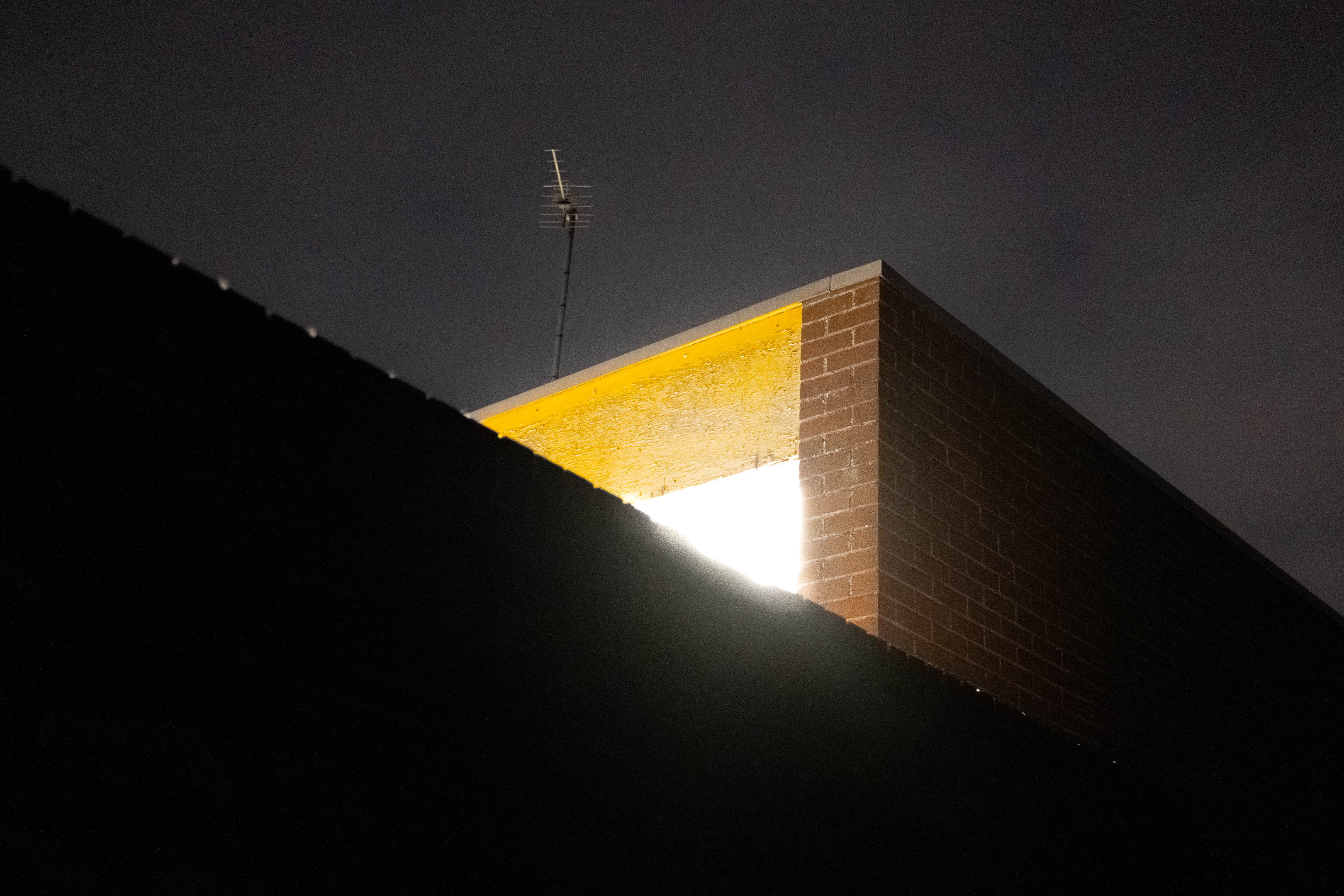 A bright light emanating from behind a wall. Taken on the Fujifilm X100VI by Connor Redmond.