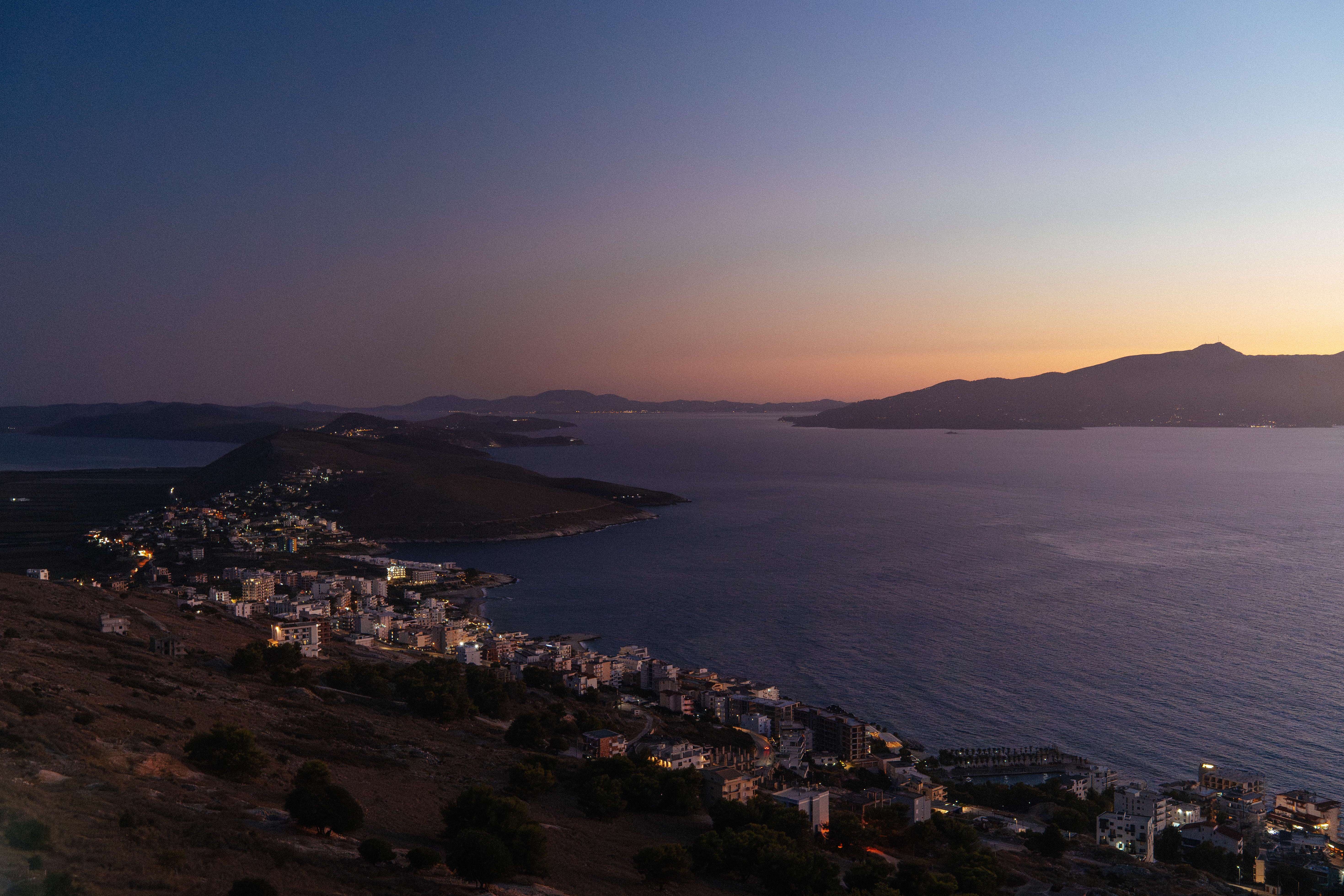 An ISO test on the A7 III of a wide landscape shot of the coast in Italy. The ocean fills the majority of the frame, with a soft sky at dusk above.