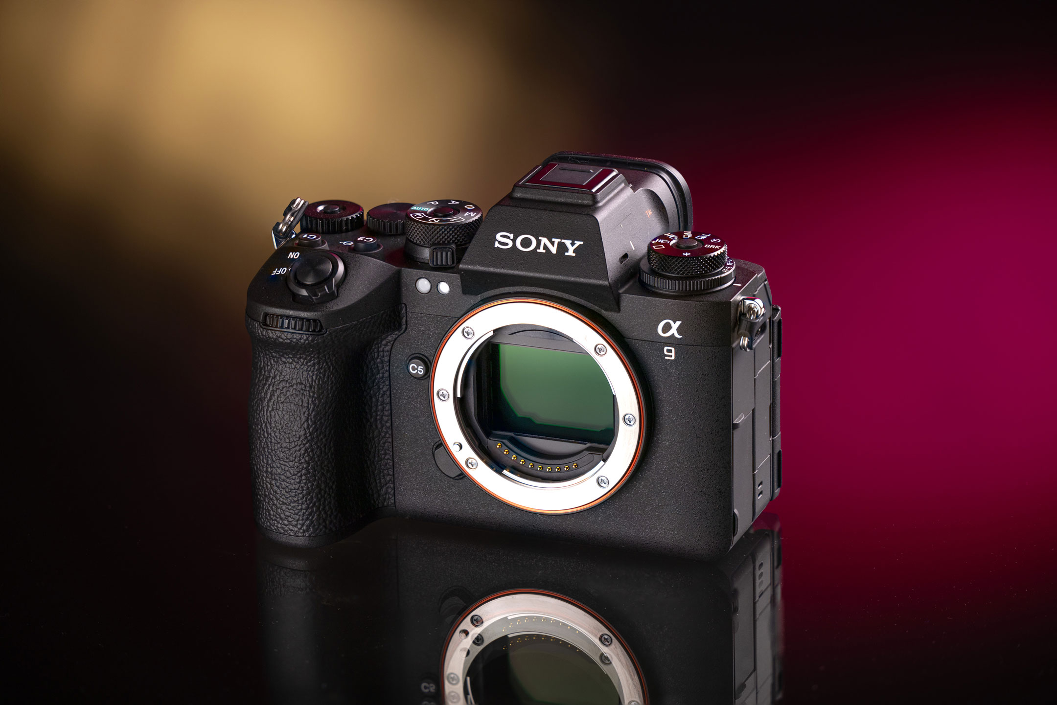 Used Sony A9 III on a dark background with red and yellow bokeh lights