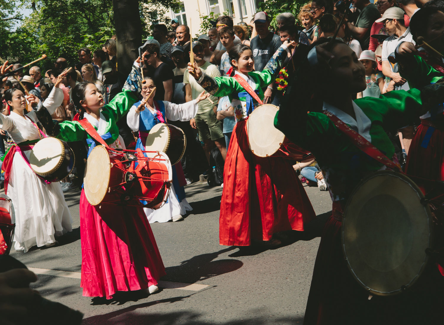 People with traditional robes and drums at a parade, shot by Stefanie Schmid Rincon with the Canon EOS R6.