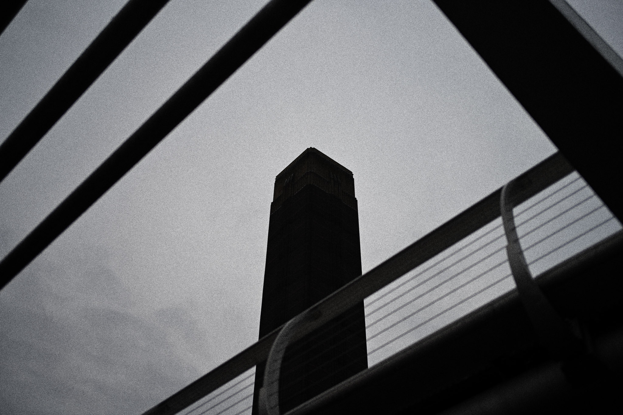 Black and white architectural picture with concrete pillars and contrasty lighting, photographed with the Nikon Zf to demonstrate the film style grain feature, by Jakub Golis.