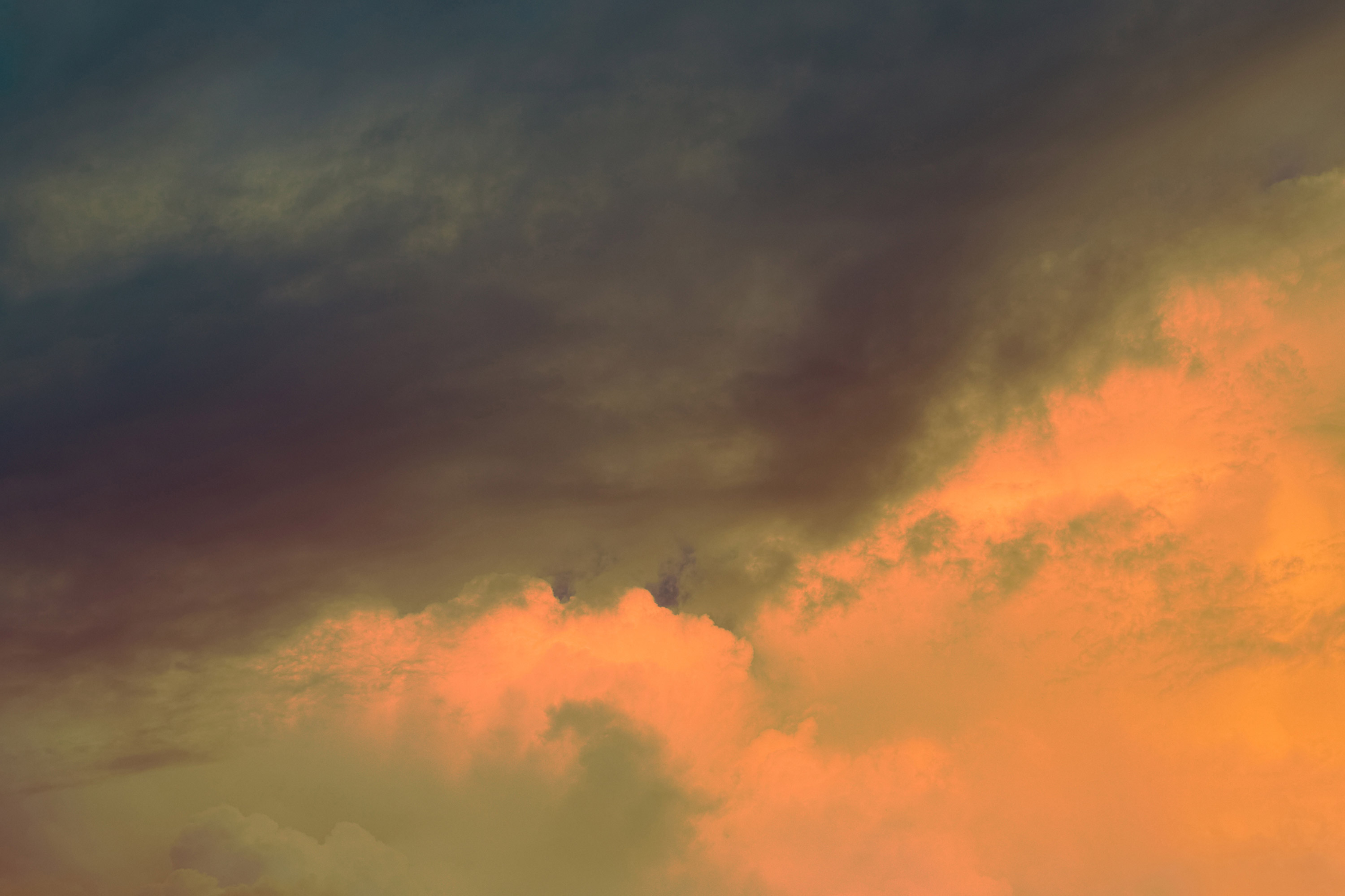 Clouds coloured orange and grey, shot and edited by Steph O’Connor