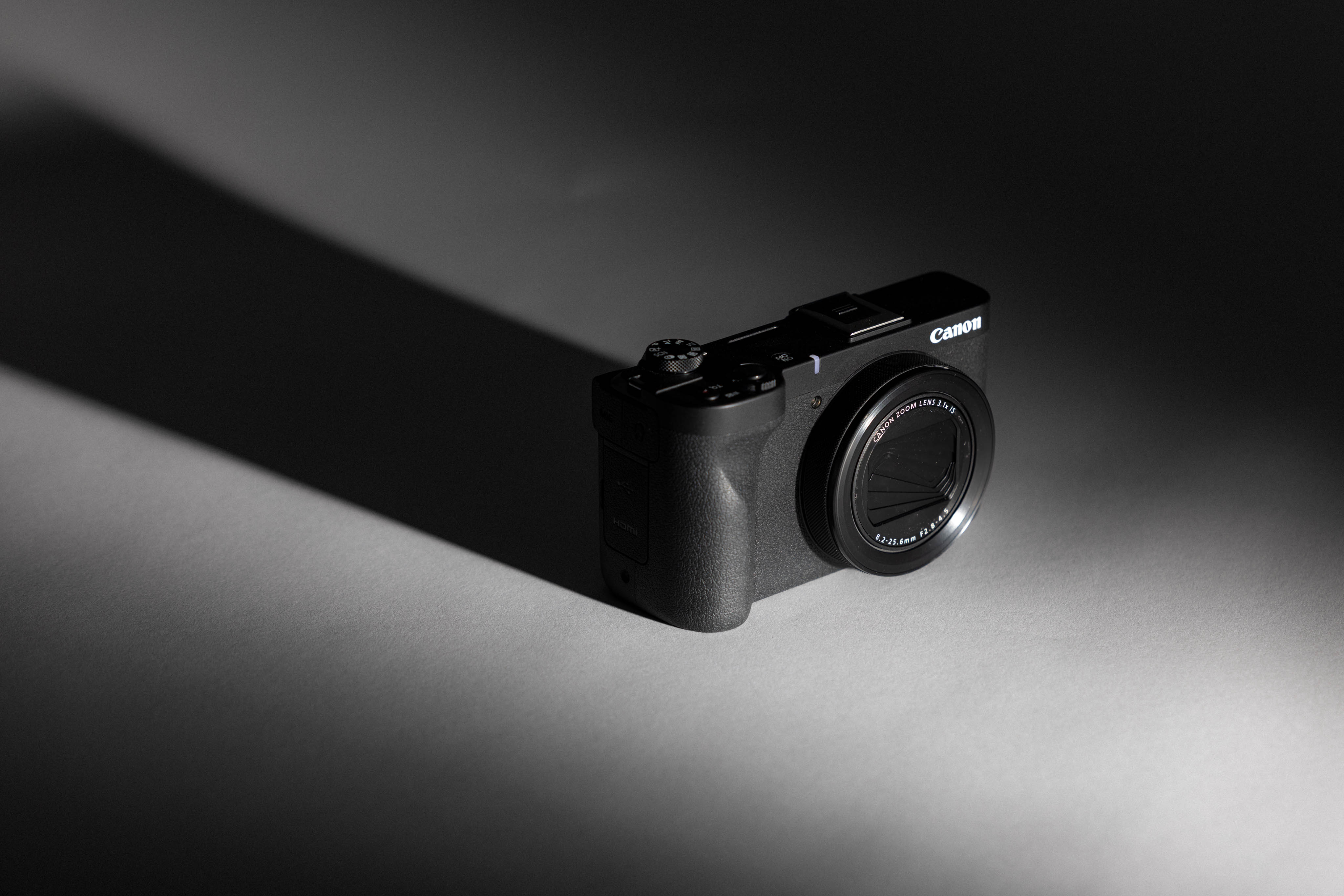 Tabletop kitshot of a used Canon PowerShot V1 from MPB with a black and white background, image by Connor Redmond.