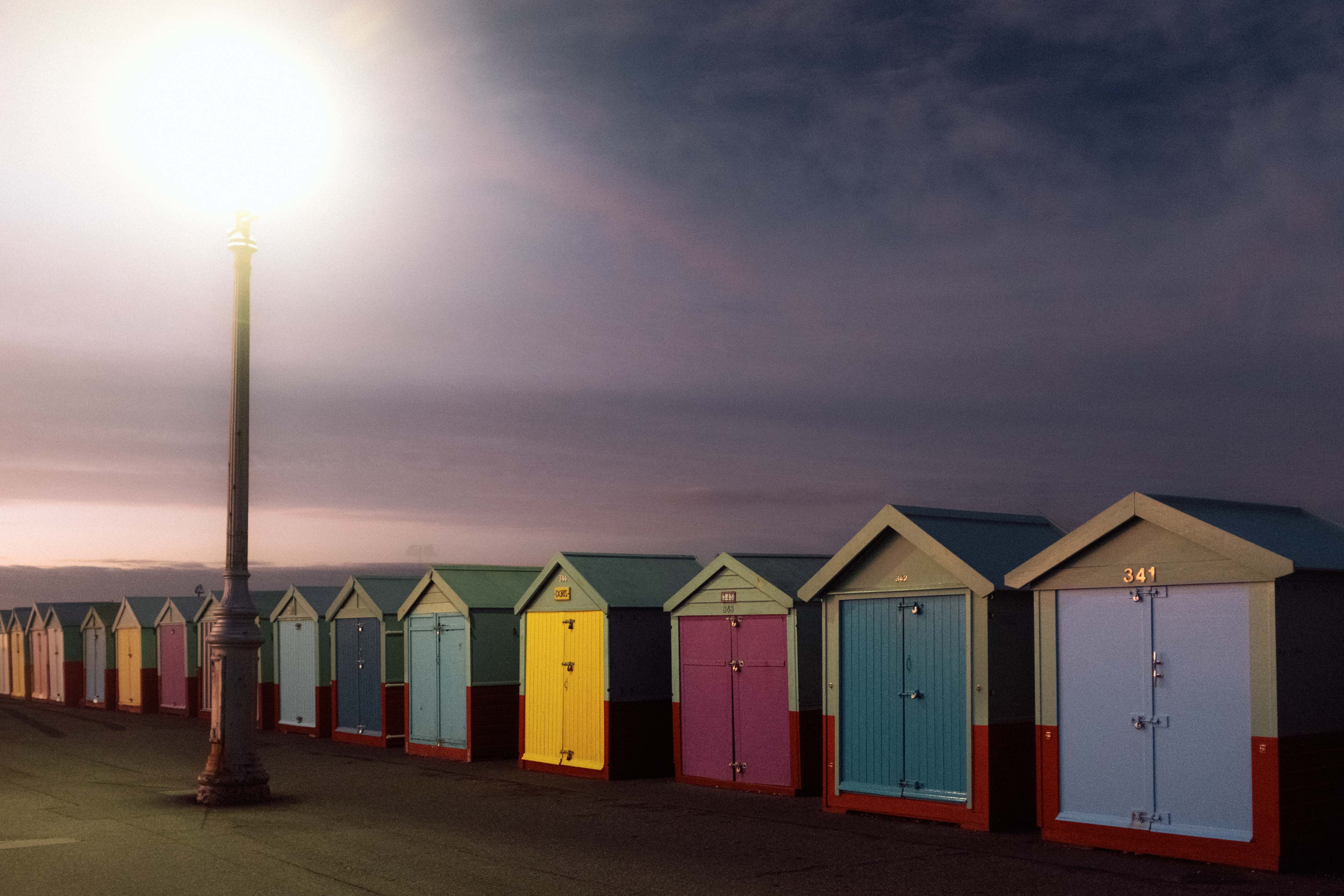 A row of seaside huts all with a different colured door. Taken by Connor Redmond on the Fujifilm X100F.