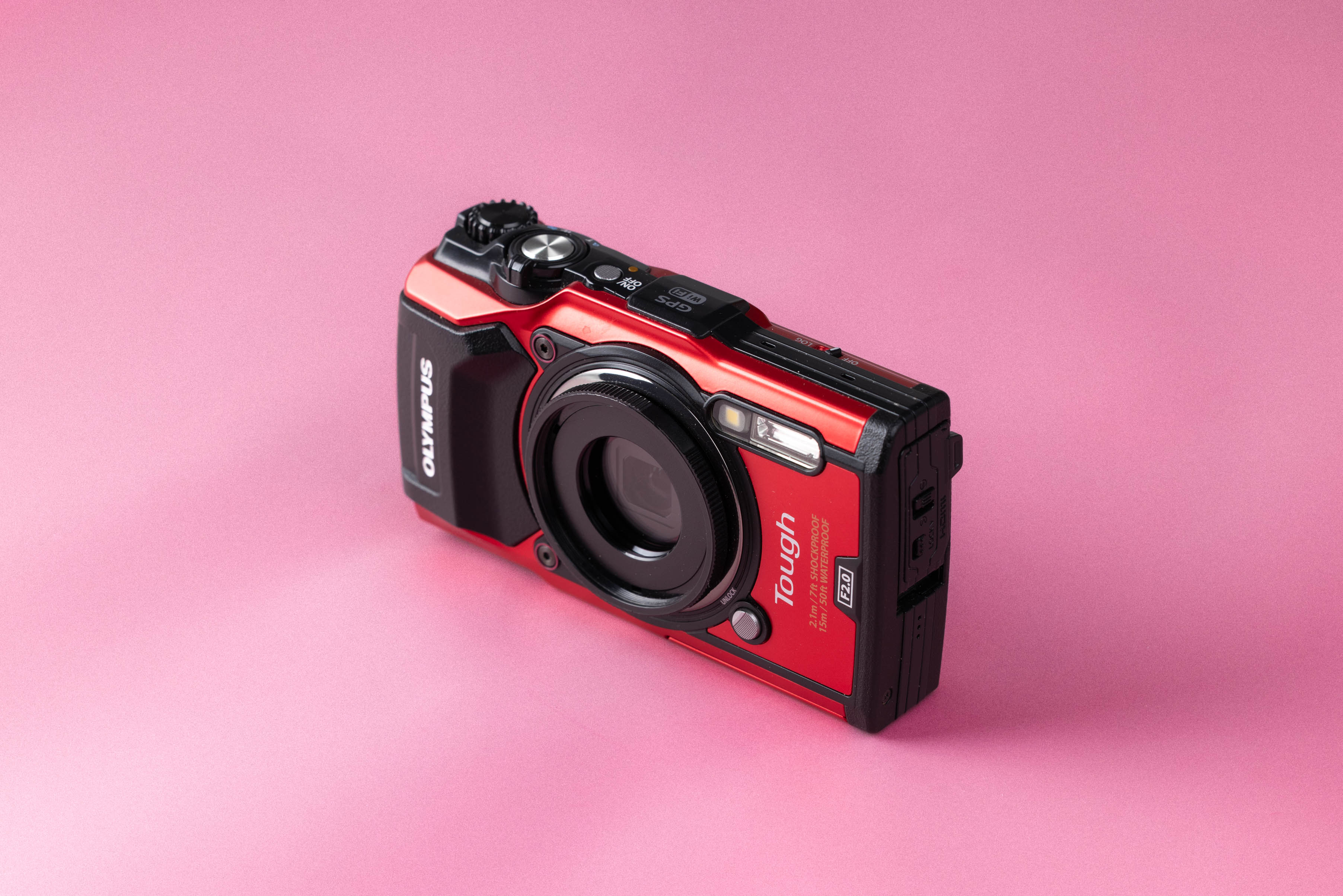 Olympus Tough TG-5 on a soft pink background.