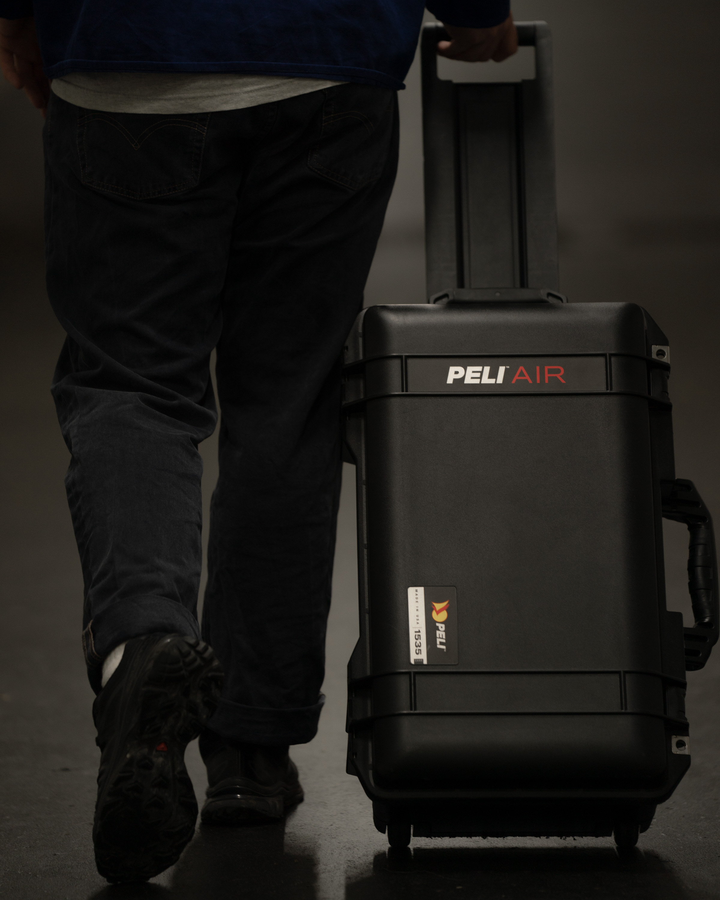 A person pulling a Peli AIR roller case
