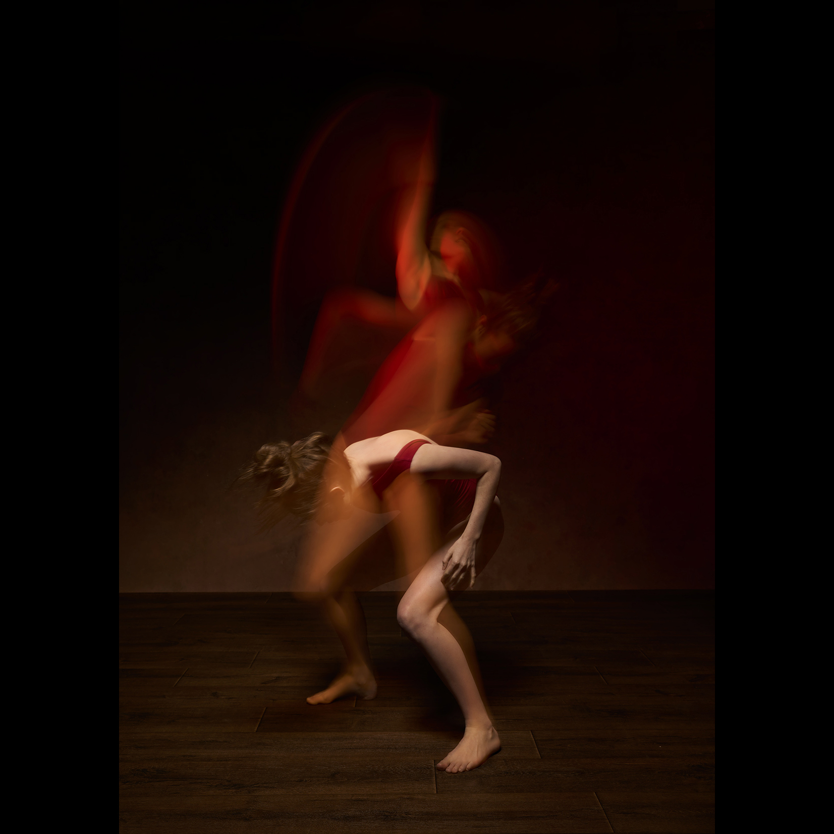 Dancer in red shown in multiple exposures, by Lorna Allan
