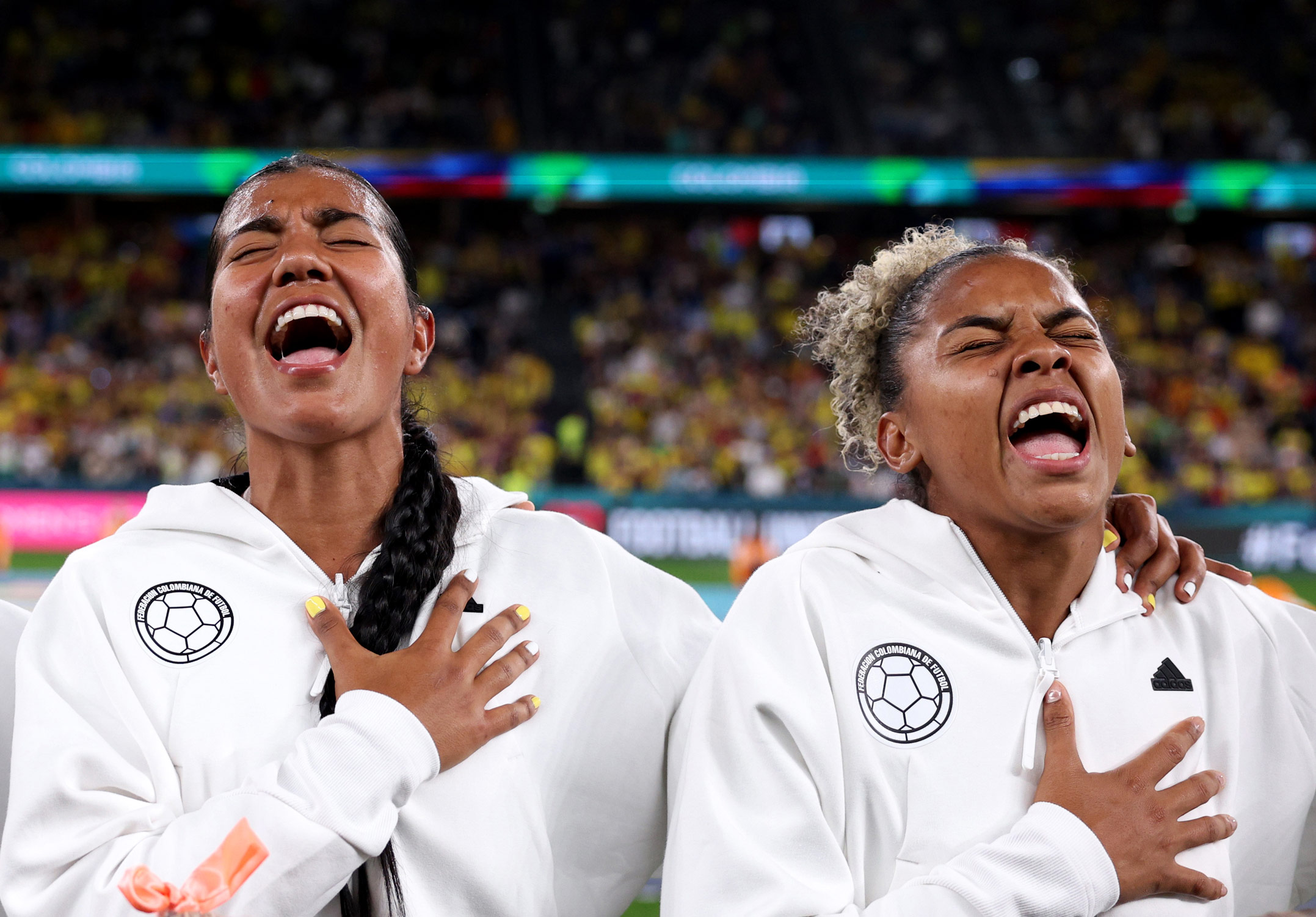 Daniela Arias and Jorelyn Carabali of Colombia sing the national anthem during the FIFA Women’s World Cup Australia & New Zealand 2023 match between Colombia and Germany. Photo by Elsa Garrison taken on a Canon EOS R3.