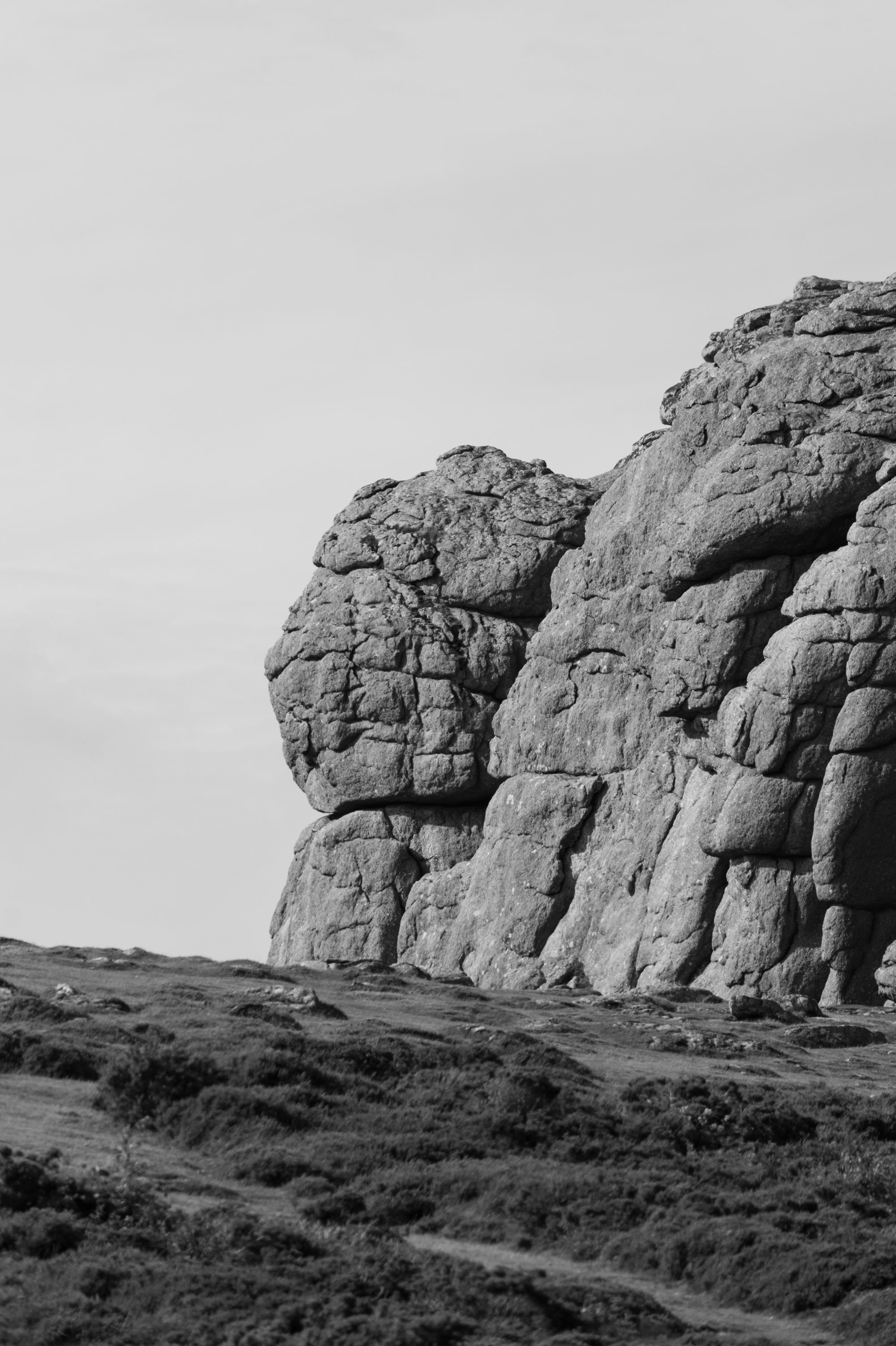 A black and white photo of rock formations in Dartmoor National Park. Photo by Amy Moore with the Panasonic S1R II.